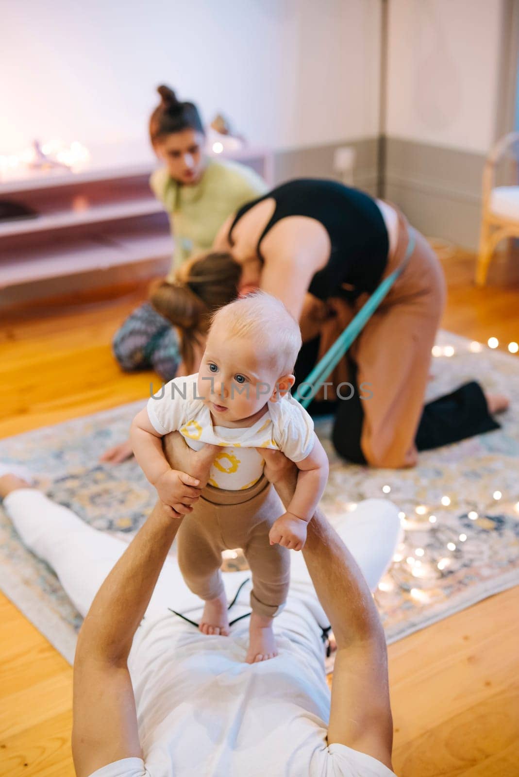 In a serene and wellnessfocused setting, a heartwarming scene unfolds as parents bond with their cherished babies