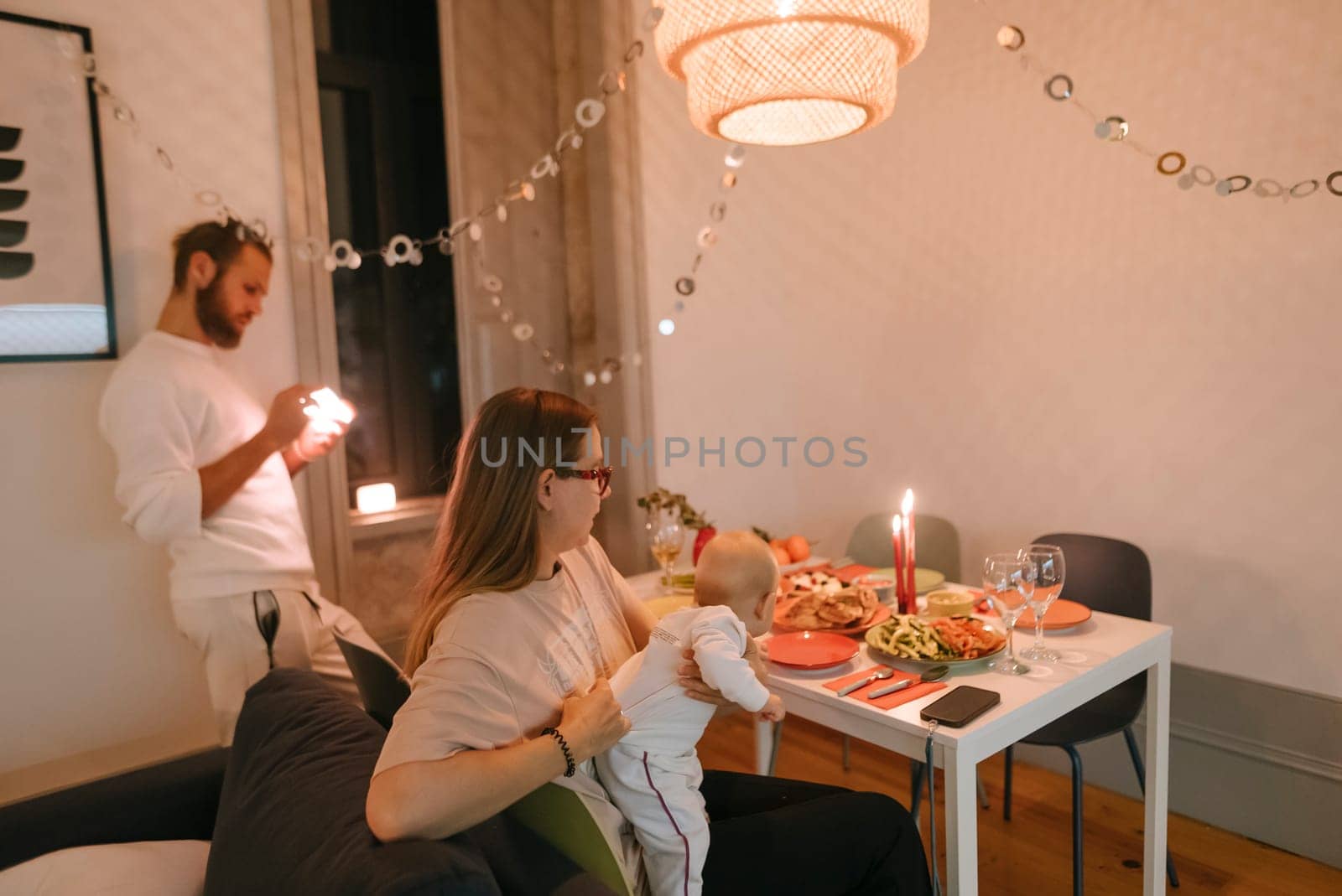 A heartwarming and inviting family dinner scene that showcases a baby surrounded by beautiful festive decor