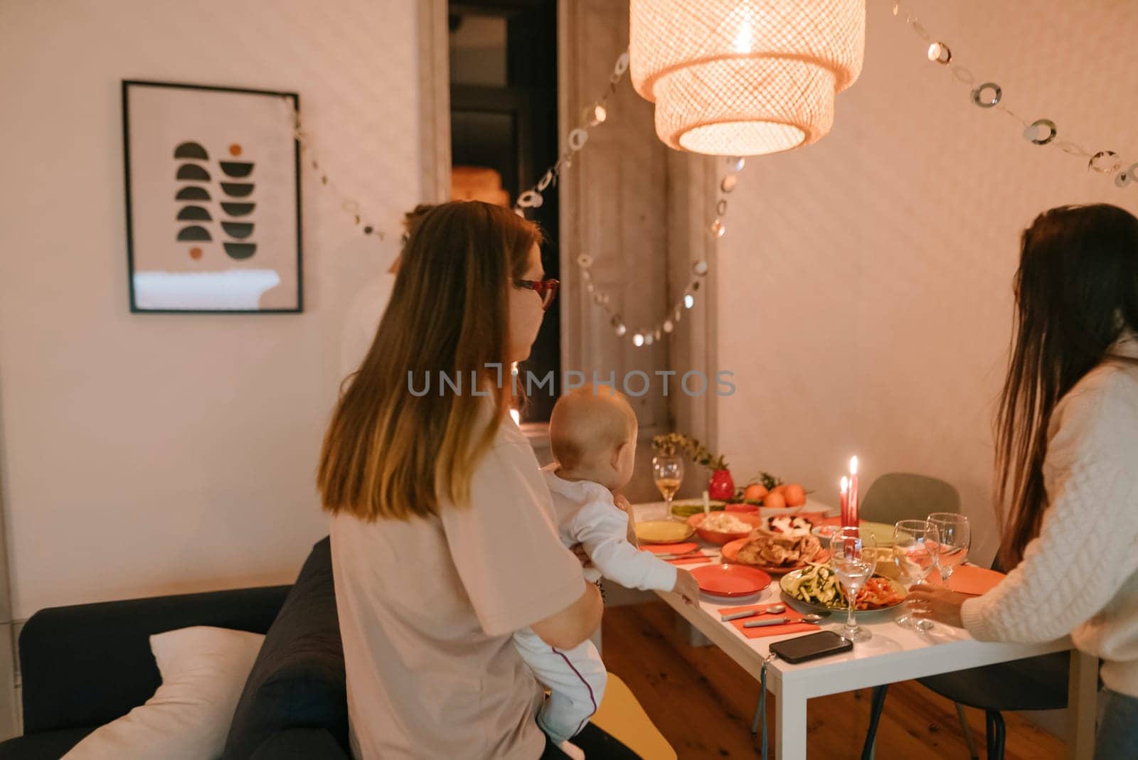 A joyful gathering with laughter, a beautifully set table, cherished moments, and cozy lighting all around