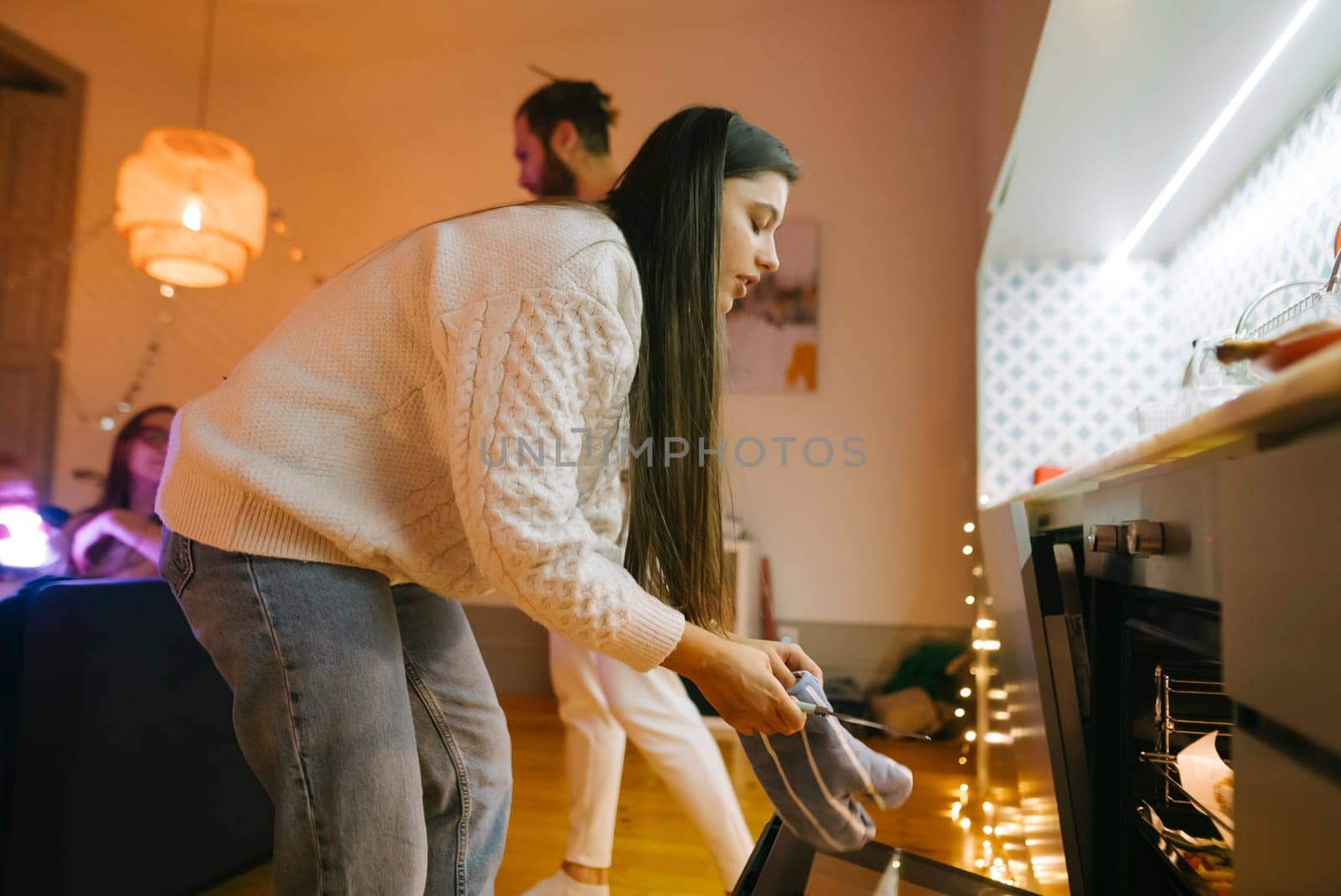 A delightful group of friends happily enjoying the art of cooking together in a warm and inviting kitchen setting