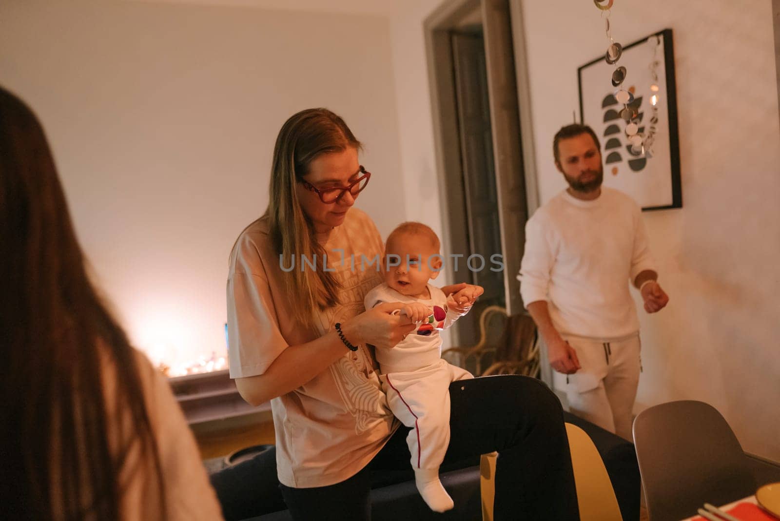 Capturing a heartfelt and warm family moment with a baby during a cozy and delightful gathering event