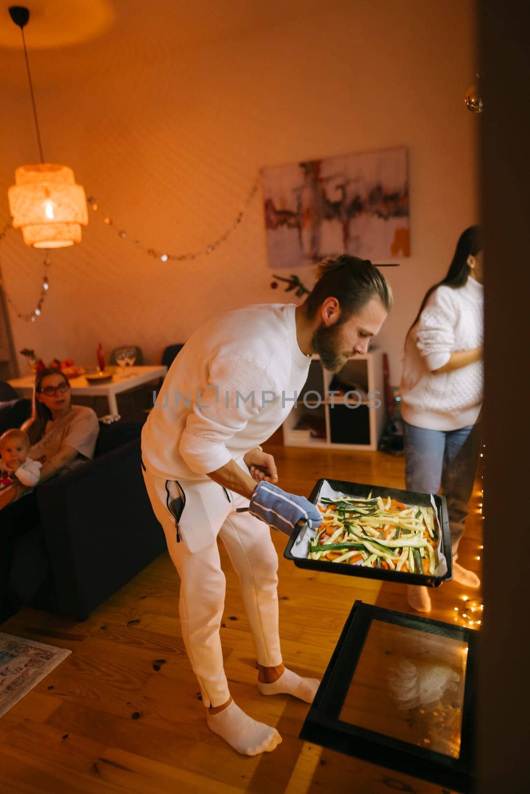 A delightful and warm gathering where friends come together to enjoy cooking in a stylish home setting
