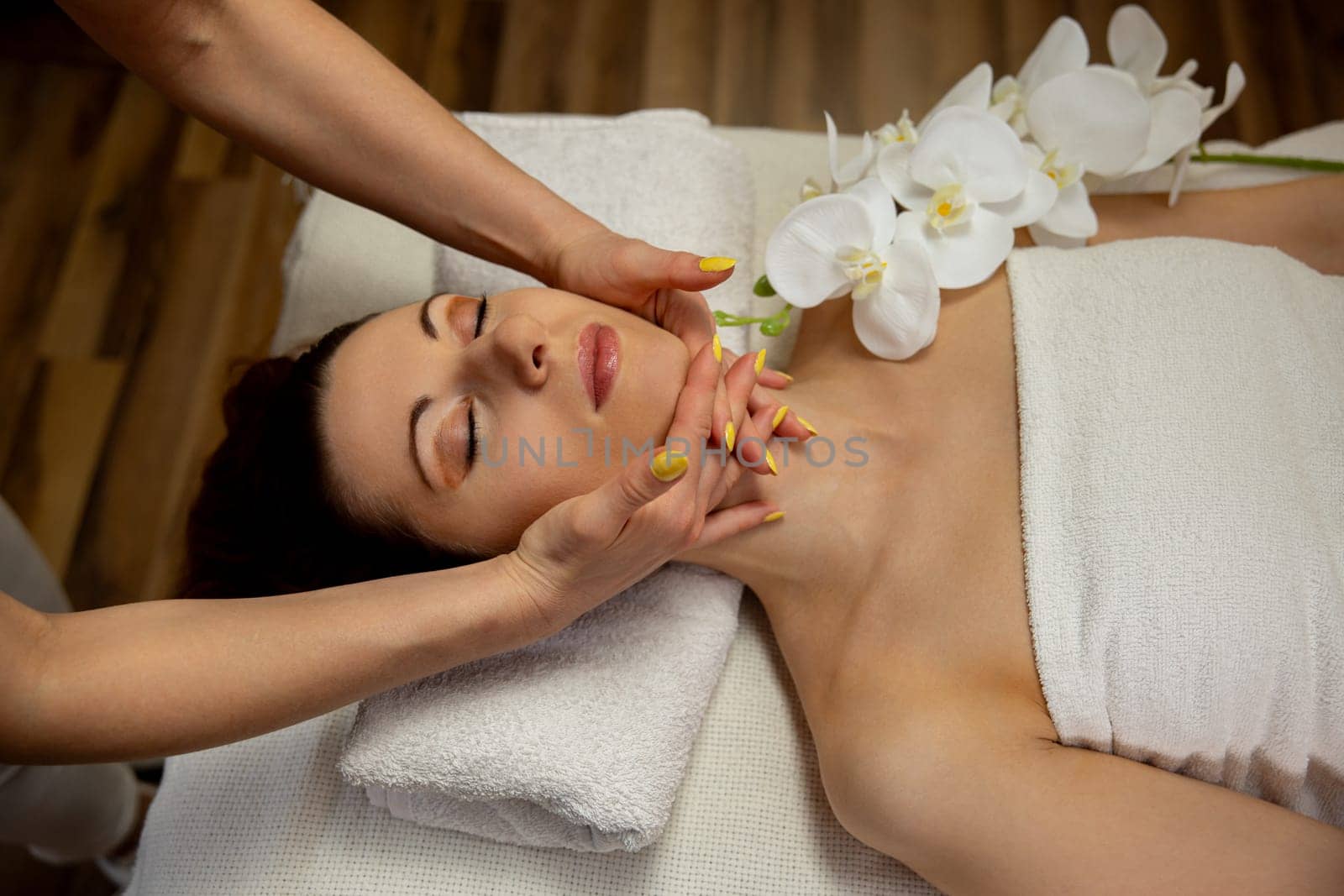 A tranquil spa scene with a luxurious facial massage and elegant flowers for the ultimate relaxation