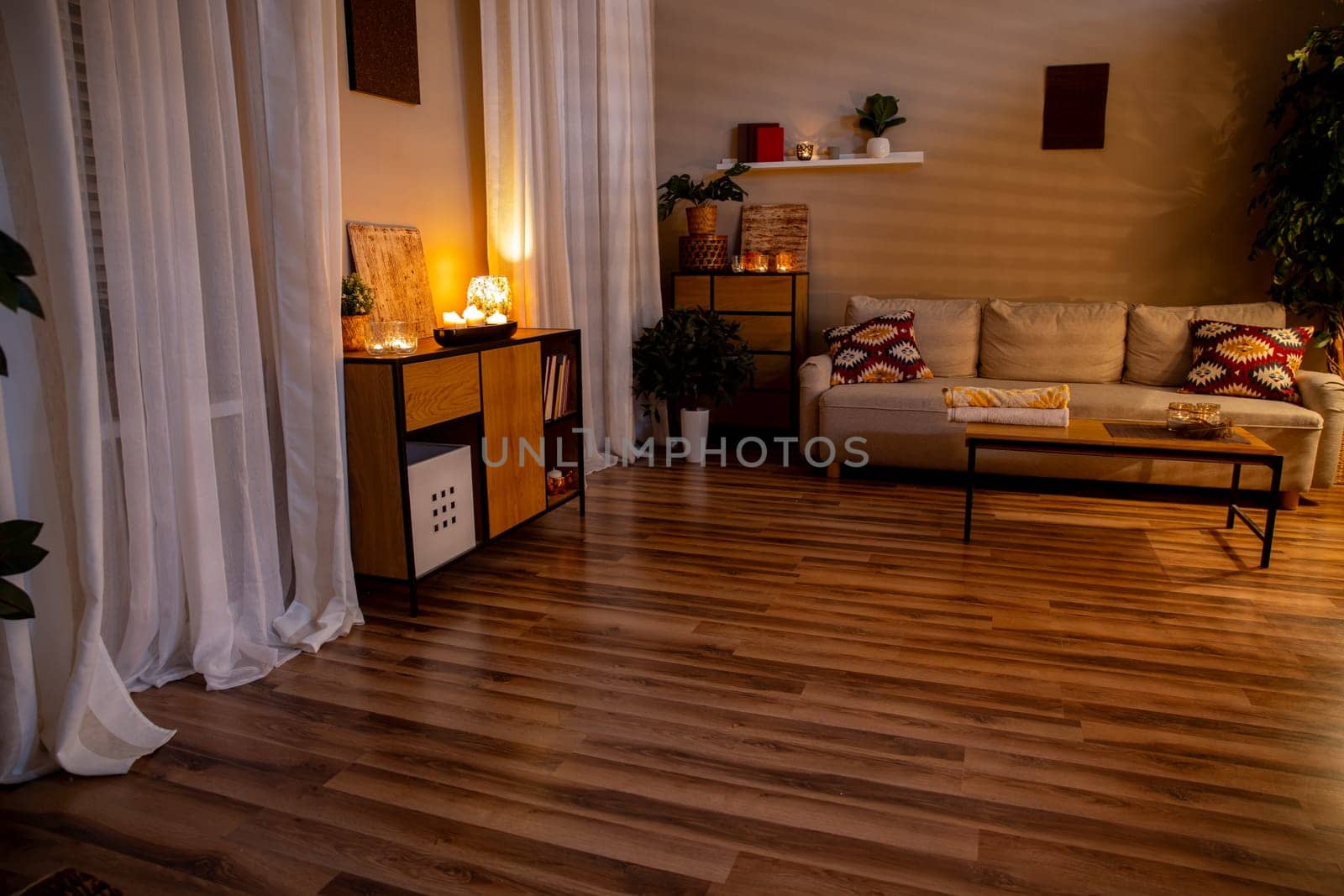 A beautifully serene living room adorned with warm lighting and sleek modern furnishings creates a tranquil atmosphere