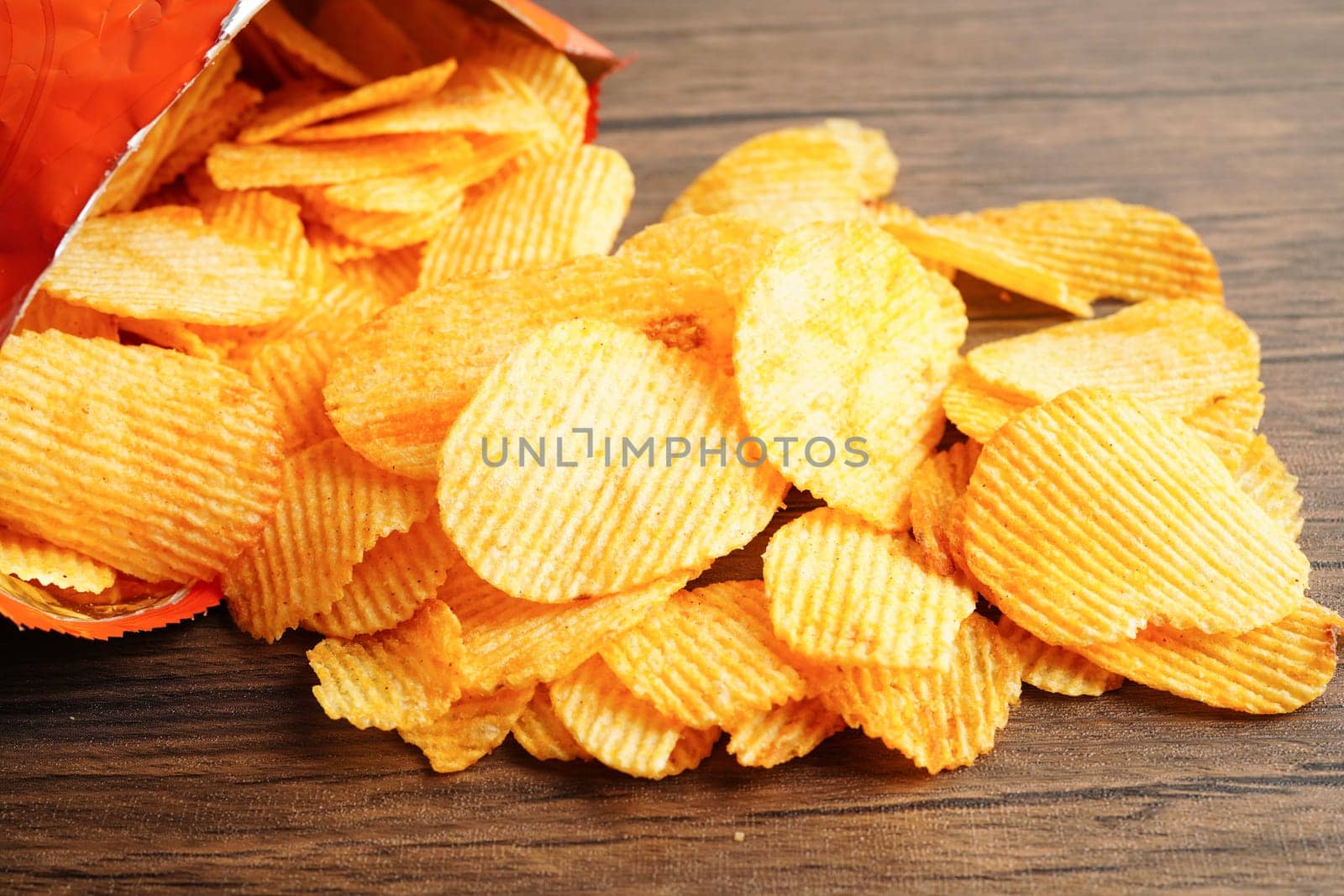 Potato chips in open bag, delicious BBQ seasoning spicy for crips, thin slice deep fried snack fast food.