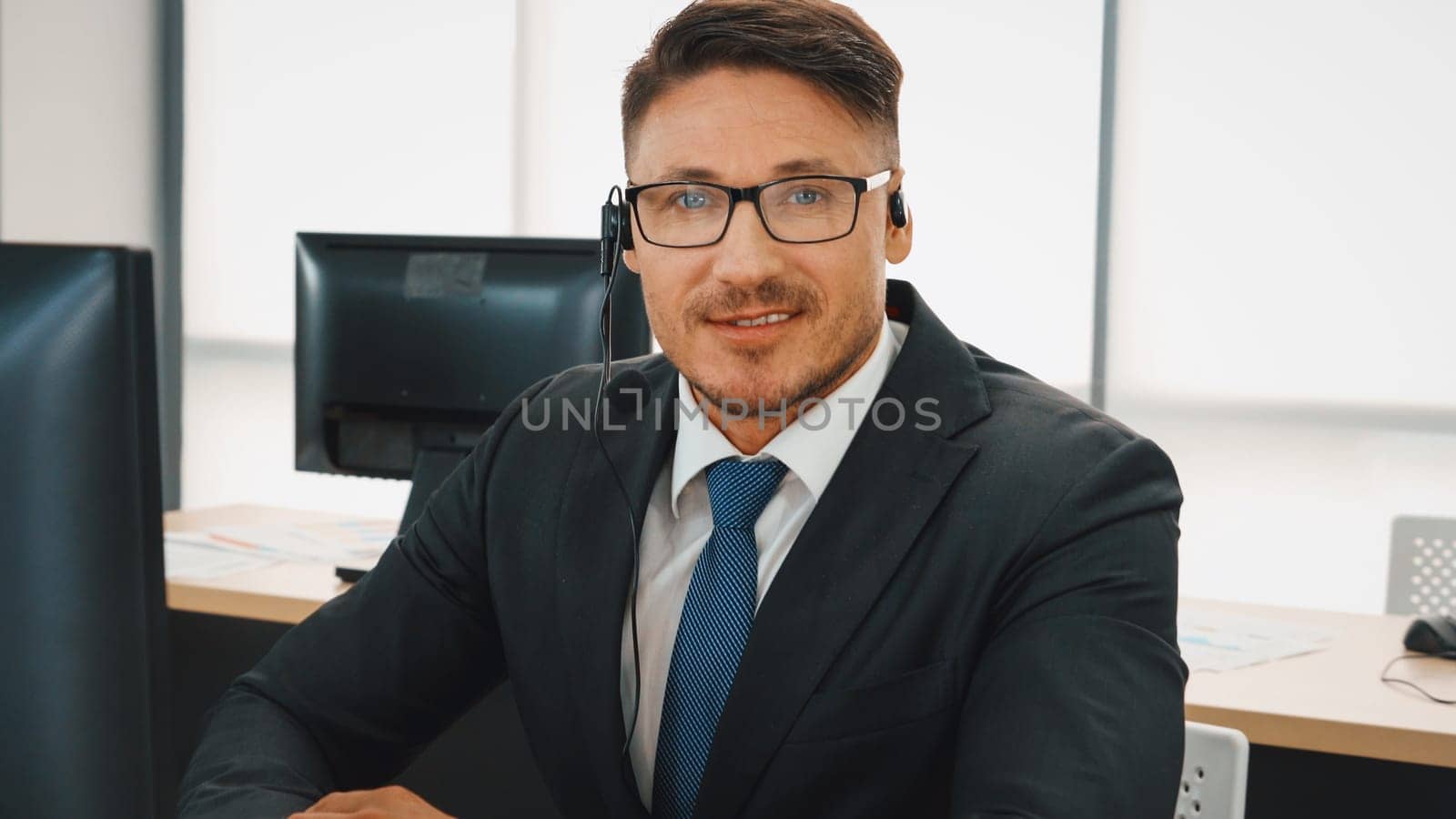 Business people wearing headset working in office to support remote customer or colleague. Call center, telemarketing, customer support agent provide service on telephone video conference call. Jivy