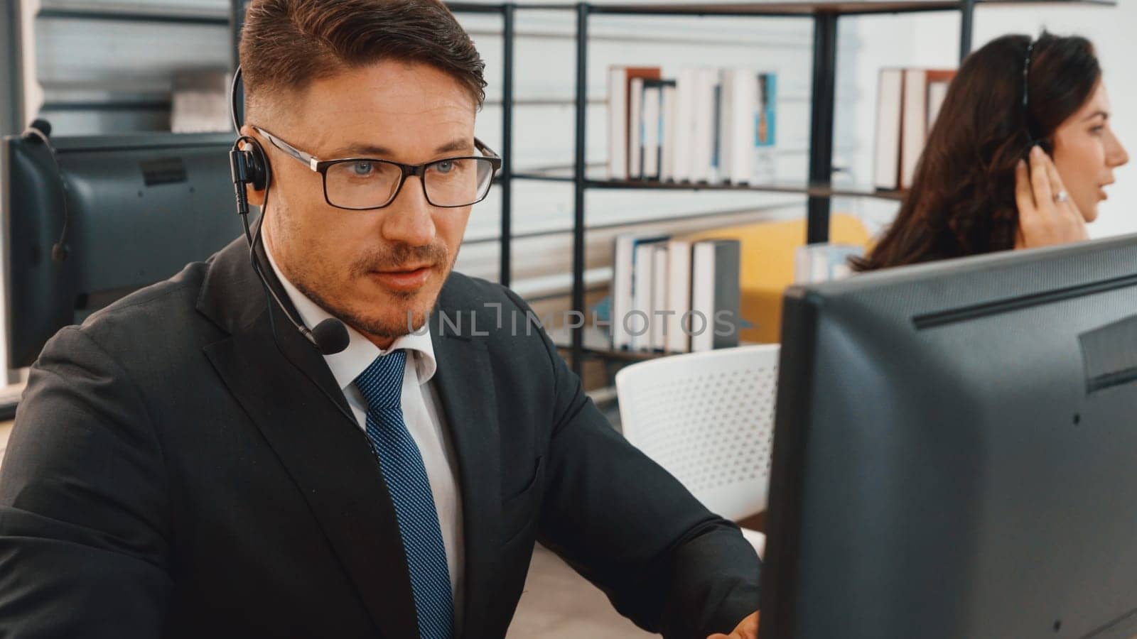 Business people wearing headset working in office Jivy by biancoblue