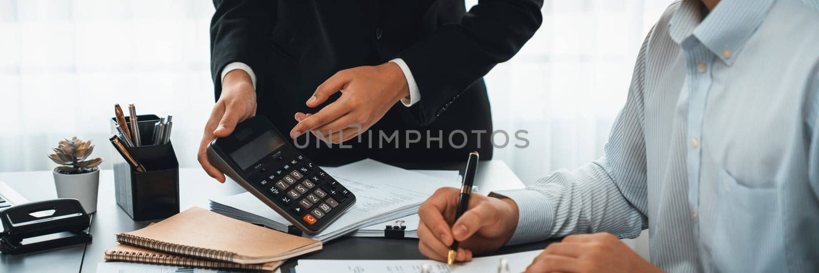 Auditor and accountant team working in office, analyze financial data and accounting record with calculator. Accounting company provide finance and taxation planning for profitable cash flow. Insight