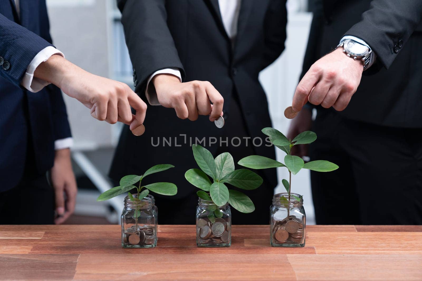 Business people put money saving into jar filled with coins and growing plant for sustainable financial planning for retirement or eco subsidy investment for environment protection. Quaint