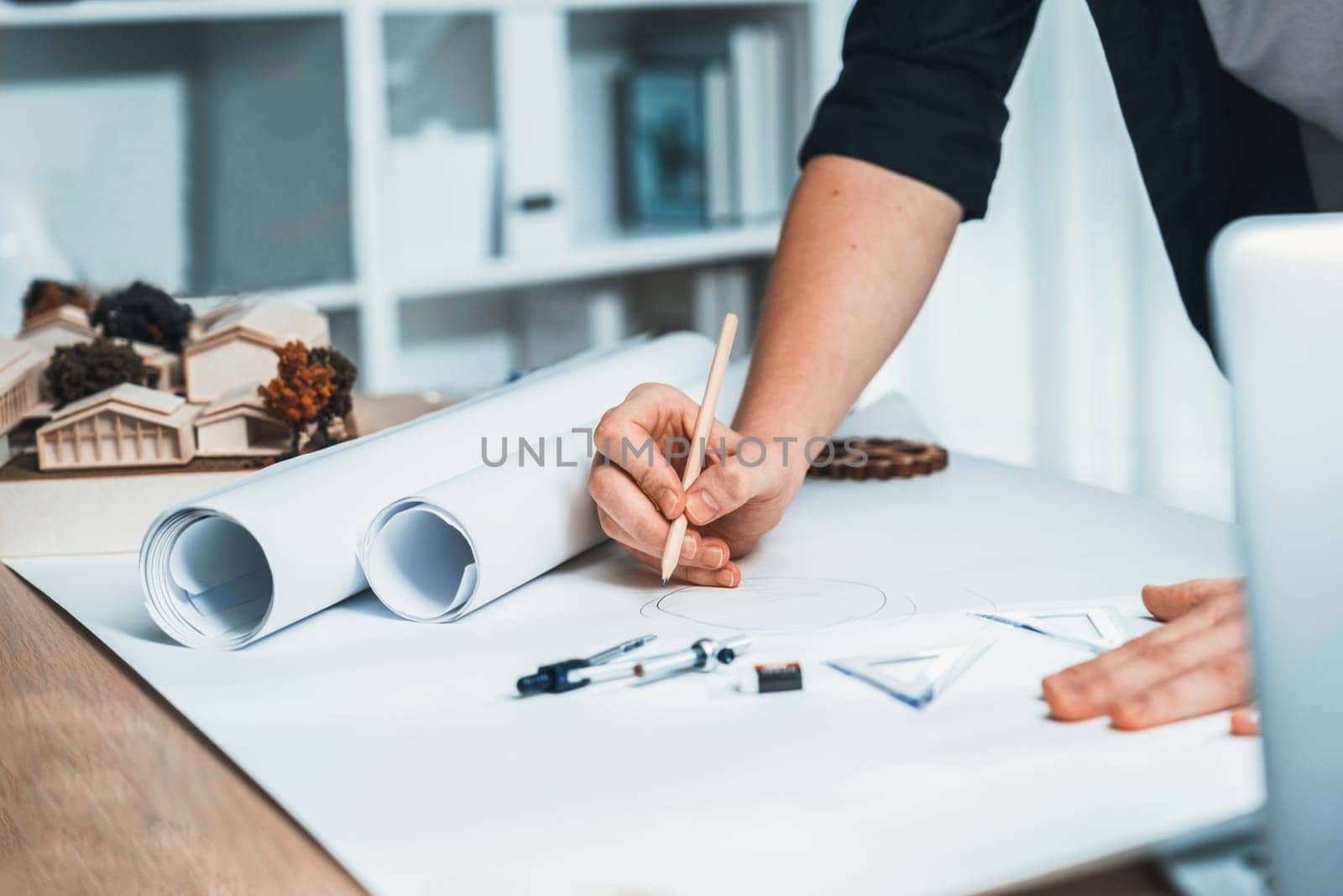 Drafting interior house design by architect designer planning home layout on blueprint paper on office desk. Architect carefully drawing home interior layout with pencil and tool. Iteration