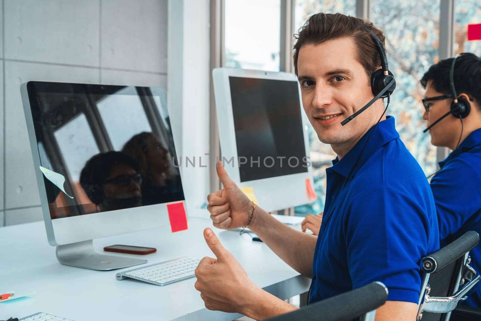 Business people wearing headset working in office to support remote customer or colleague. Call center, telemarketing, customer support agent provide service on telephone video conference call. Jivy