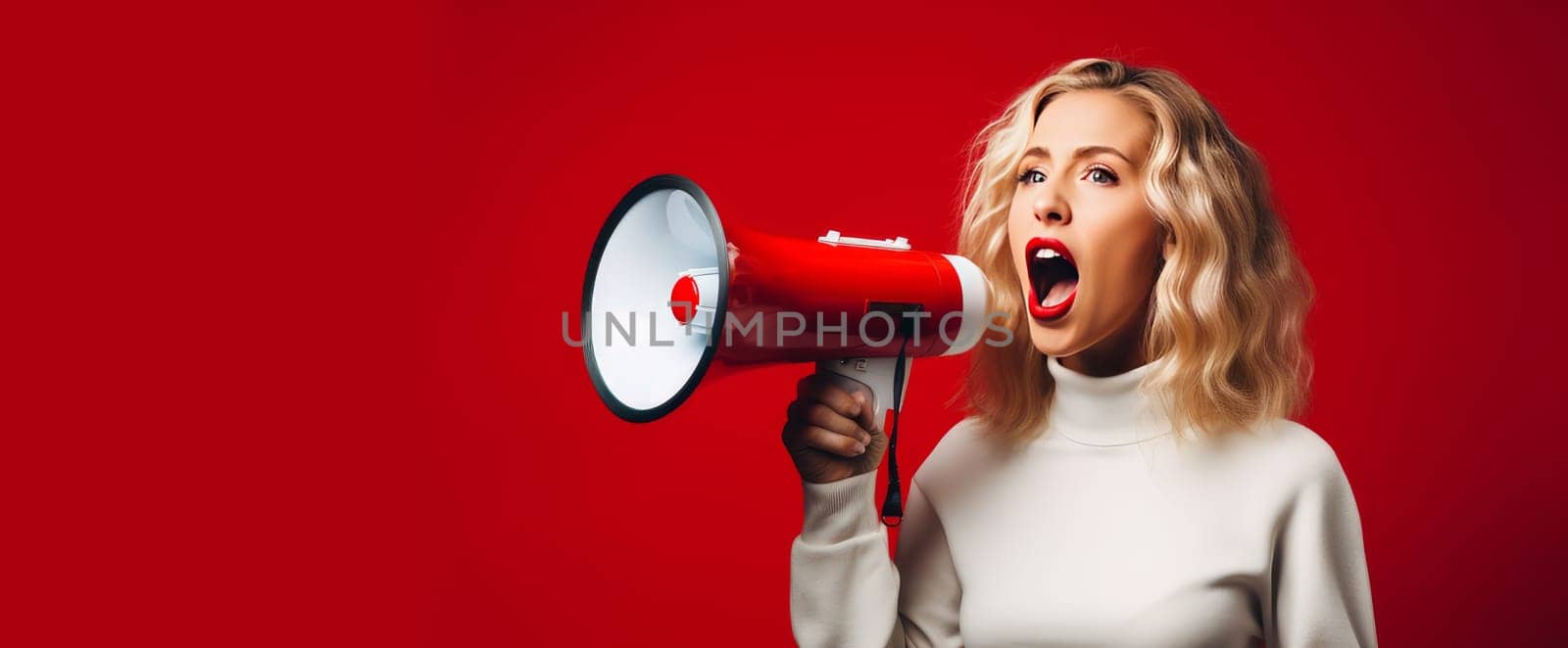 A girl on a simple red background shouts loudly into a megaphone and announces the start of the Black Friday sale. Banner