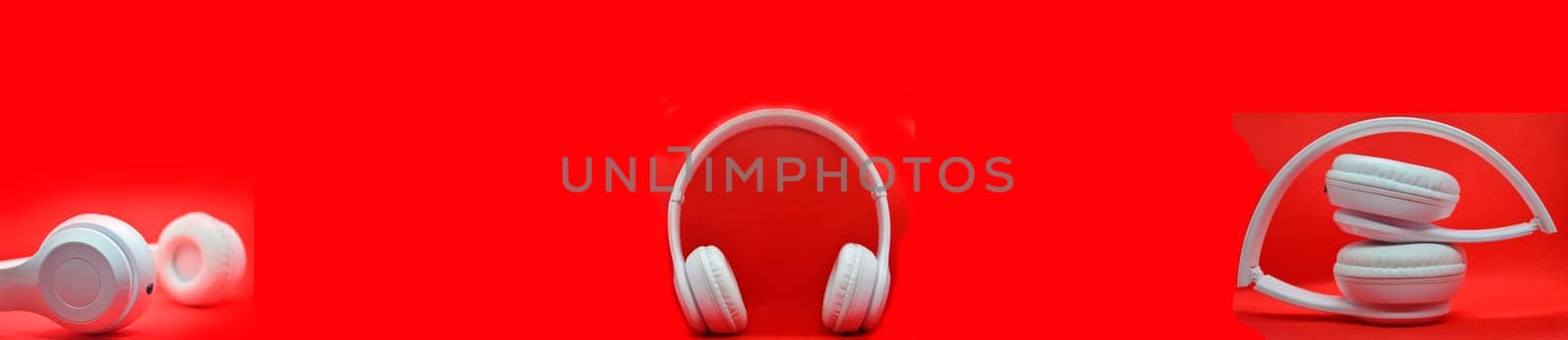 White headphones placed on a red background, used as a background image. by boonruen