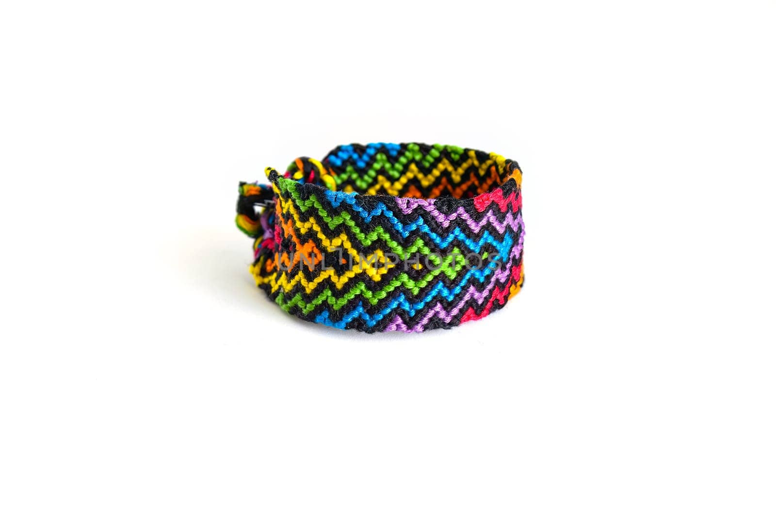 Multicolored woven DIY friendship bracelets handmade of embroidery bright thread with knots isolated on white background