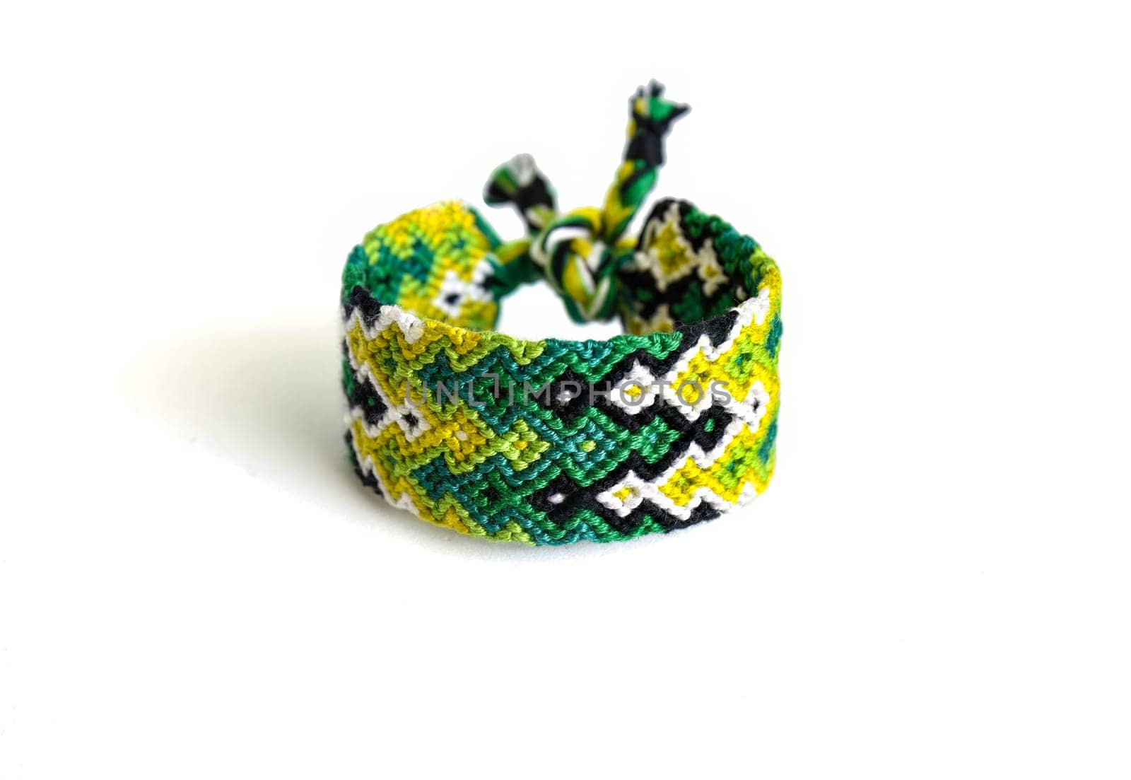 Multicolored woven DIY friendship bracelets handmade of embroidery bright thread with knots isolated on white background