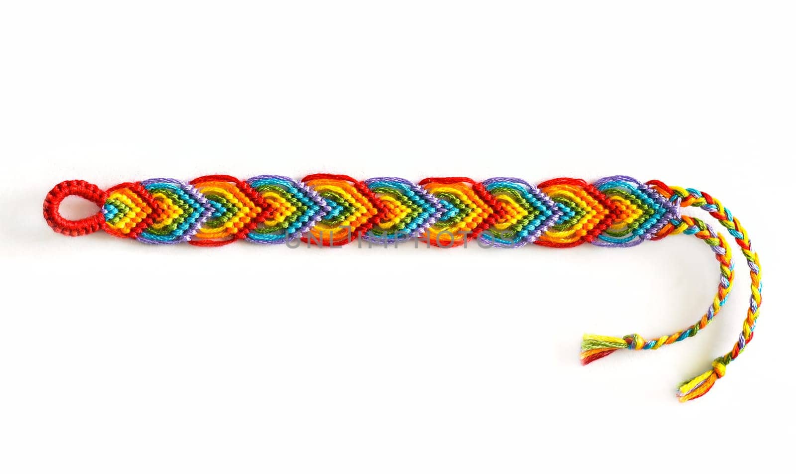 Multicolored woven DIY friendship bracelets handmade of embroidery bright thread with knots isolated on white background