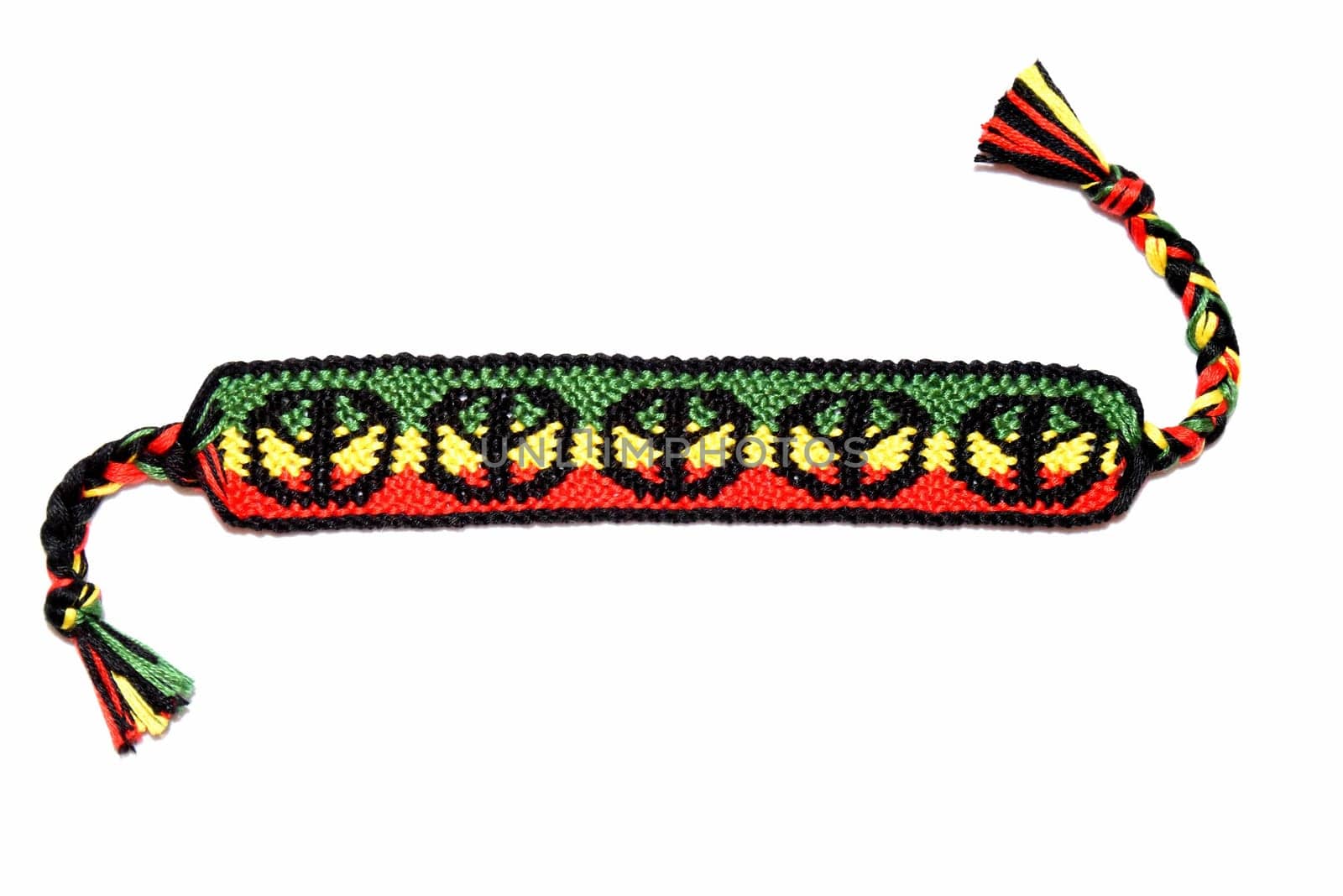 Rasta flag pattern with a peace on the DIY friendship bracelet handmade of embroidery bright thread with knots isolated on white background