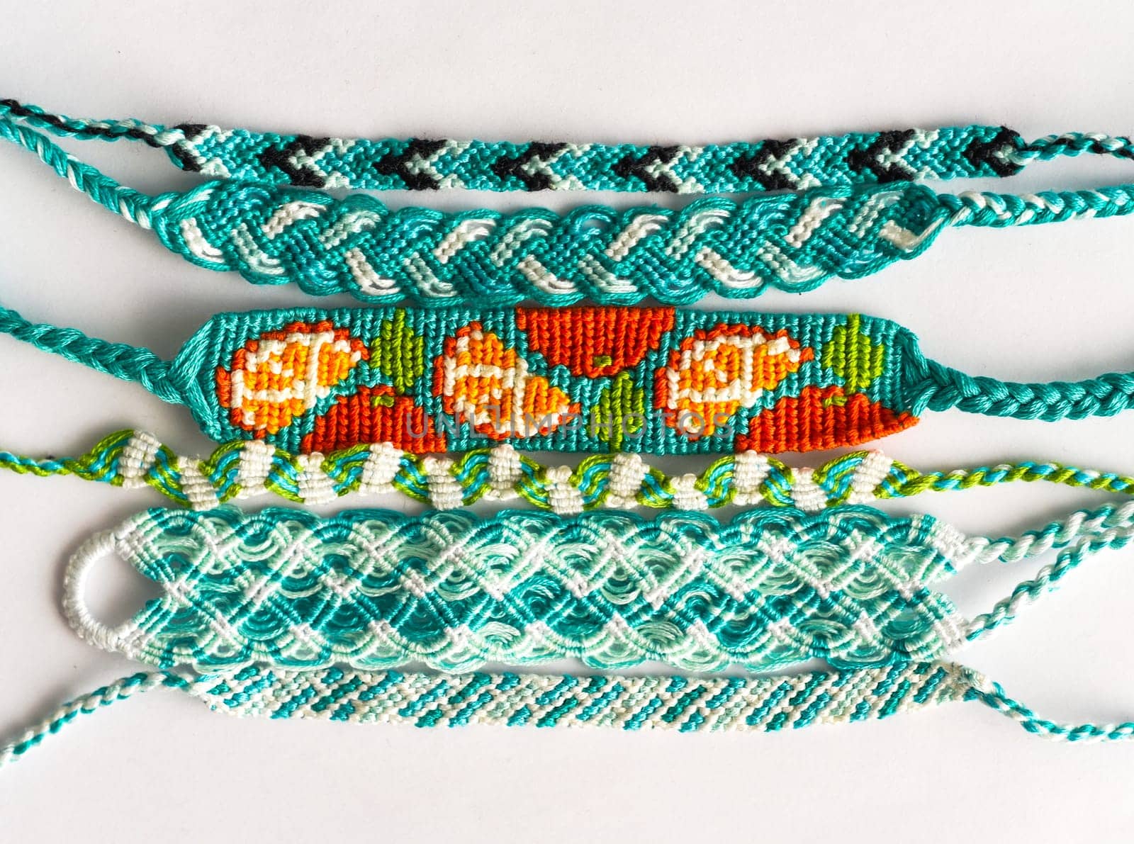 Woven DIY friendship bracelets handmade of embroidery floss with knots in blue style
