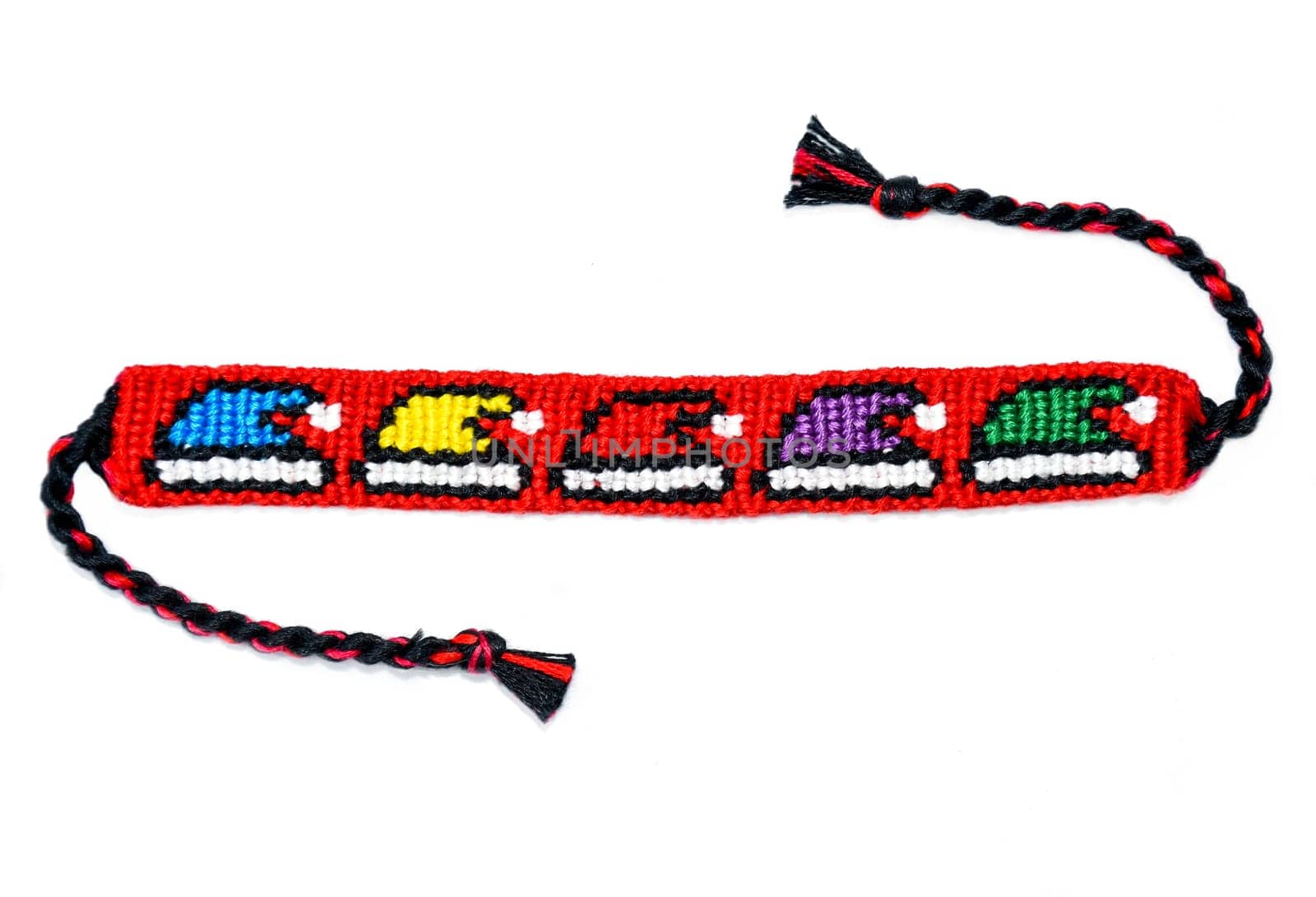 Woven friendship bracelet with Christmas alpha pattern Santa hats. Handmade of thread, isolated on white background. DIY gift idea