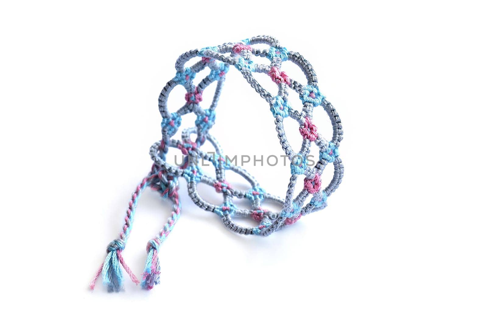 Multicolored woven DIY friendship bracelets handmade of embroidery bright thread with knots isolated on white background