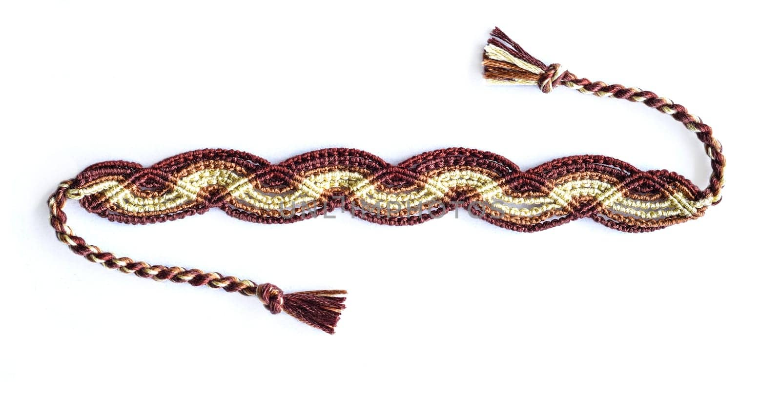 Multicolored woven DIY friendship bracelets handmade of embroidery bright thread with knots isolated on white background