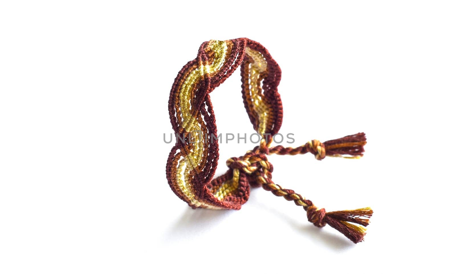 Multicolored woven DIY friendship bracelets handmade of embroidery bright thread with knots isolated on white background