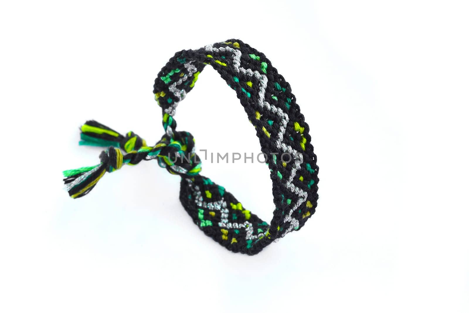Multicolored woven DIY friendship bracelets handmade of embroidery bright thread with knots isolated on white background