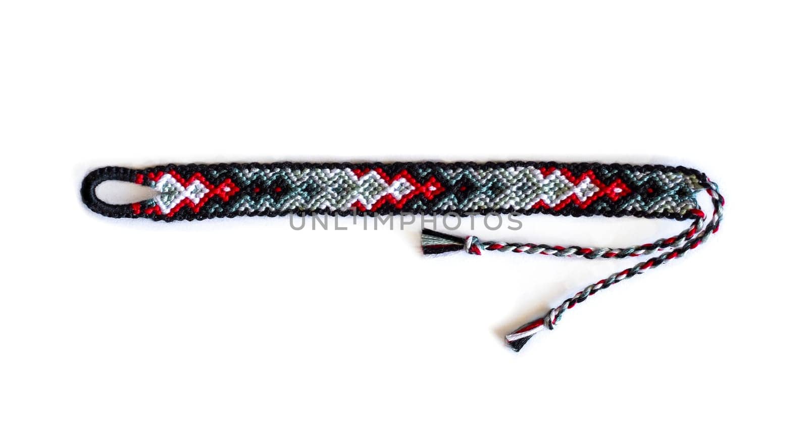 Multicolored woven DIY friendship bracelets handmade of embroidery bright thread with knots isolated on white background