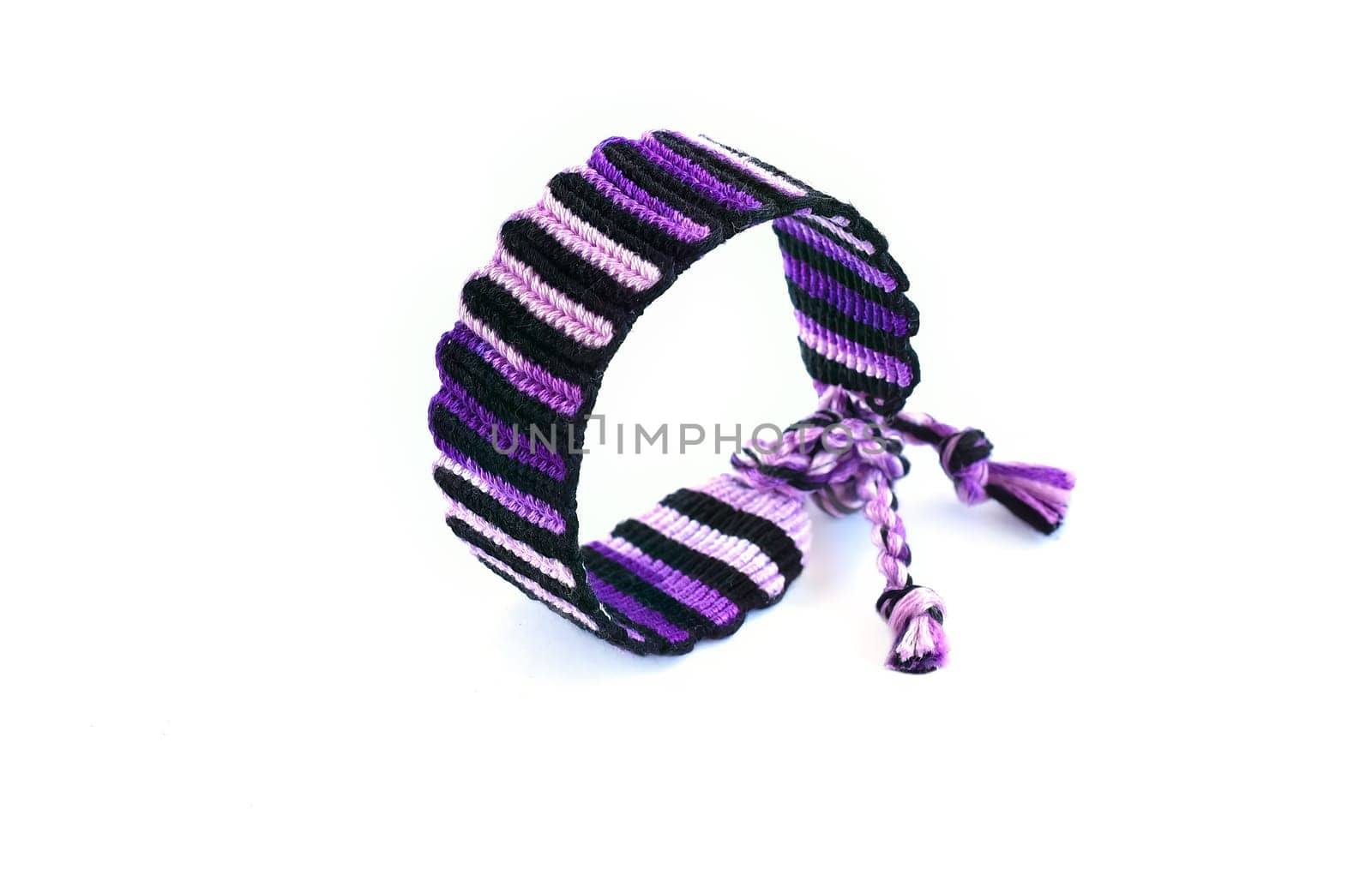 Multicolored woven DIY friendship bracelets handmade of embroidery bright thread with knots isolated on white background