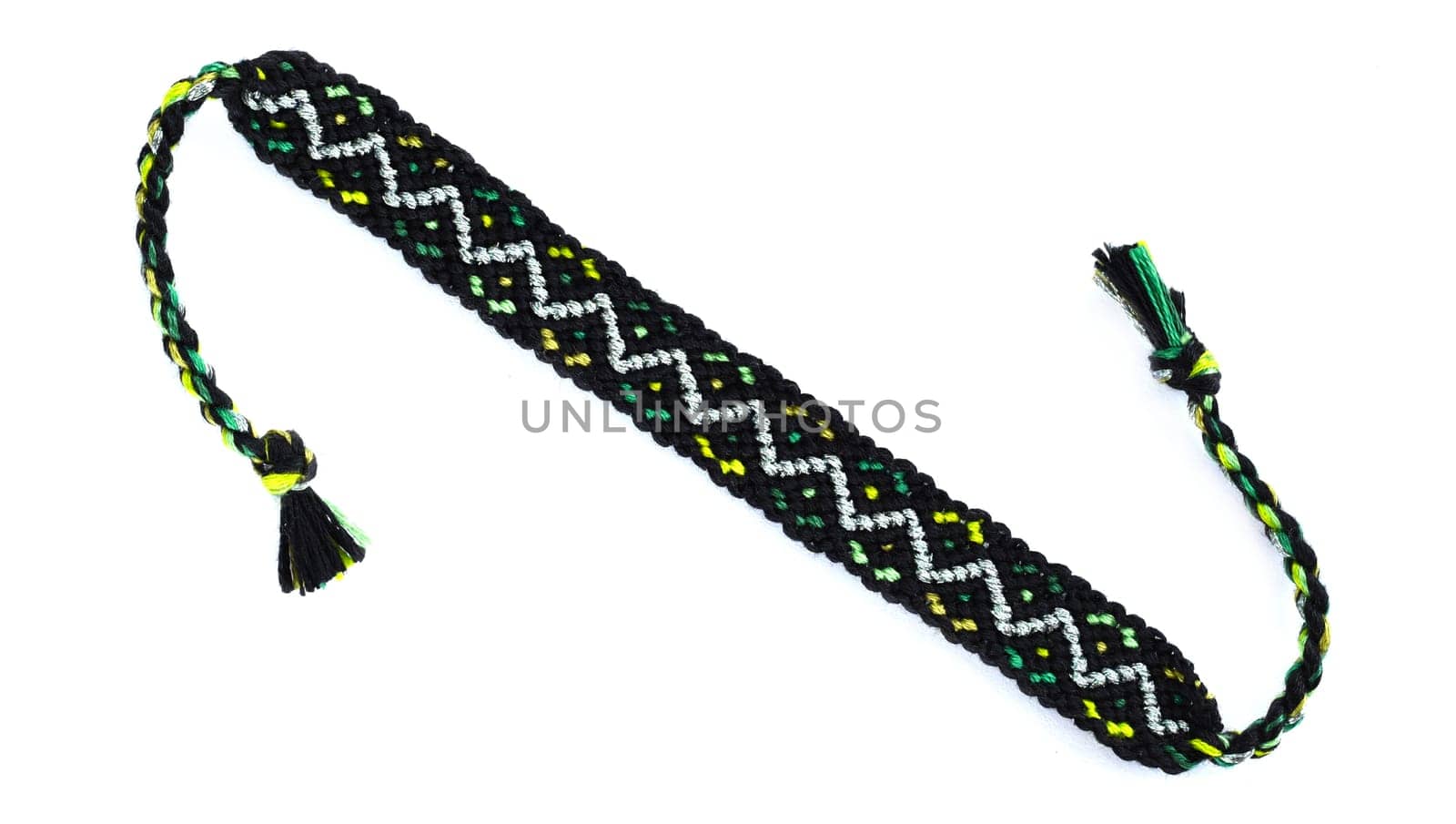 Multicolored woven DIY friendship bracelets handmade of embroidery bright thread with knots isolated on white background