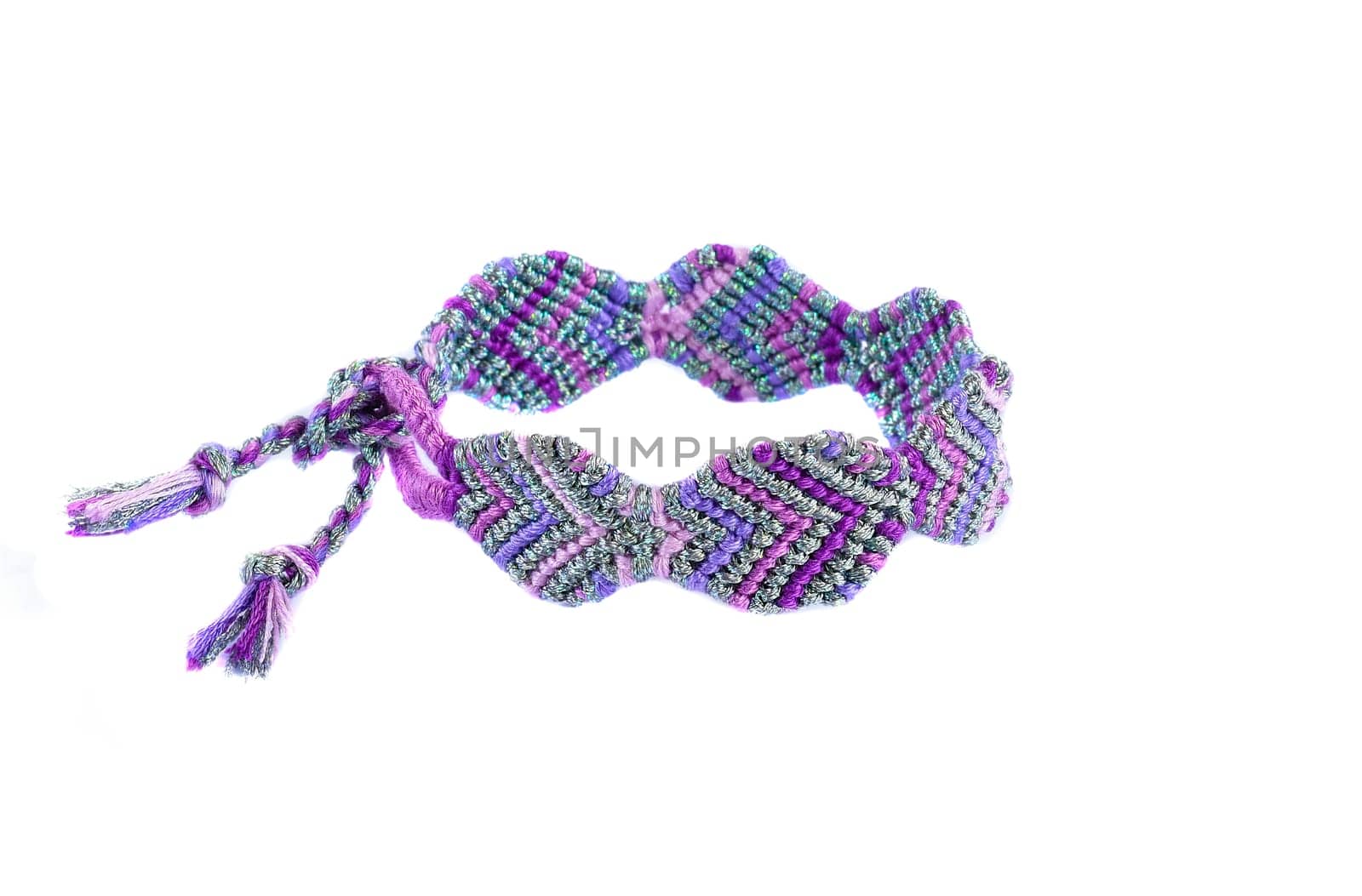 Multicolored woven DIY friendship bracelets handmade of embroidery bright thread with knots isolated on white background