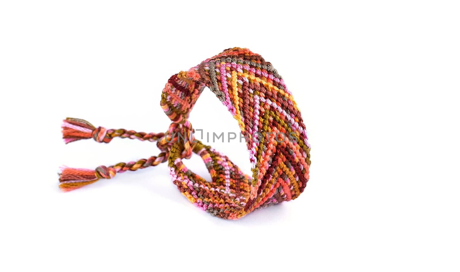 Multicolored woven DIY friendship bracelets handmade of embroidery bright thread with knots isolated on white background
