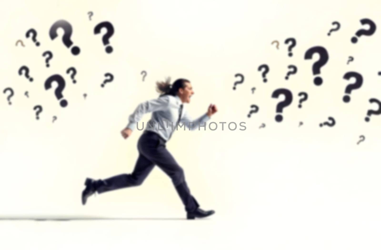 A business professional runs rapidly amid question marks, representing the pressures and uncertainties faced in addressing various challenges. Blurred picture.