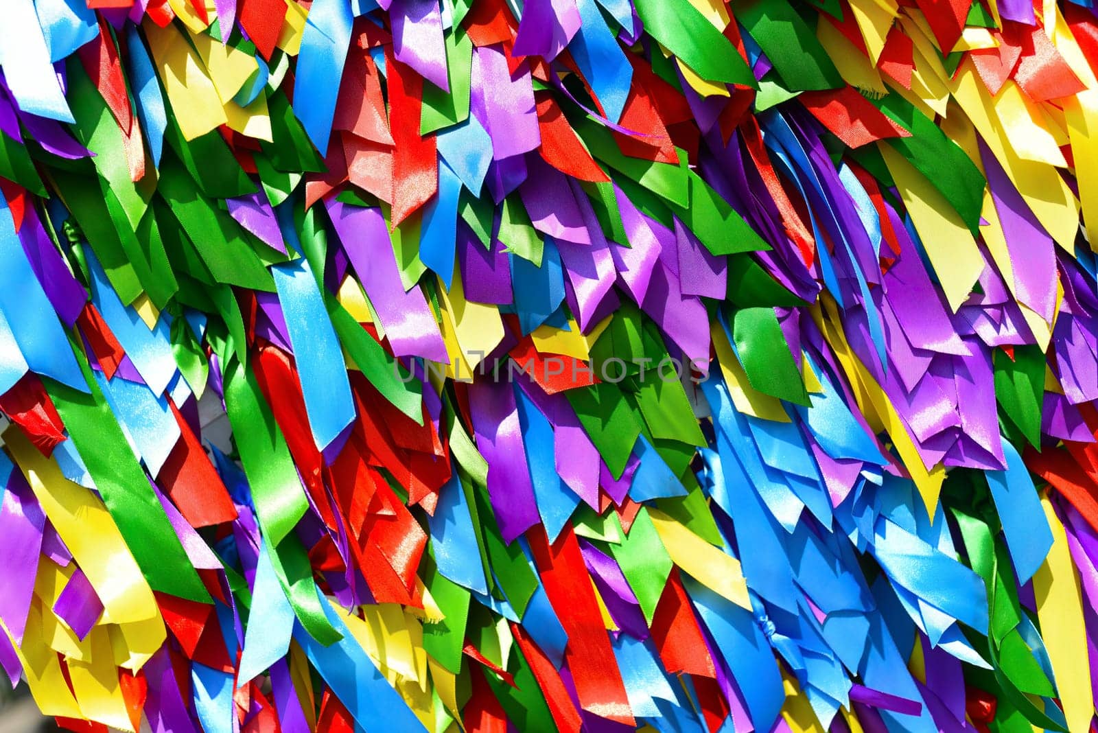 Bright background made of multicolored satin ribbons