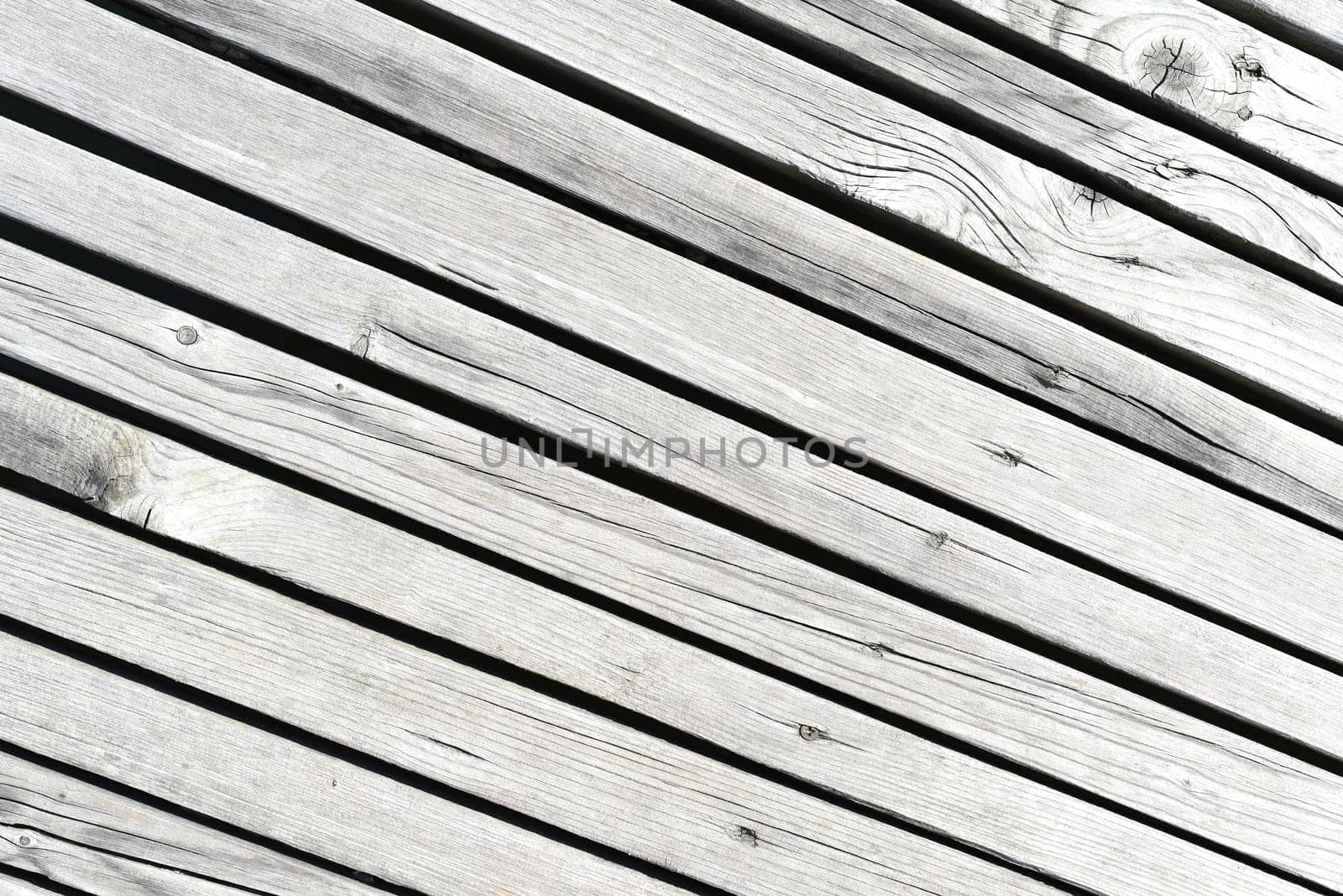 Wooden wall made of diagonal boards with light stripes. background