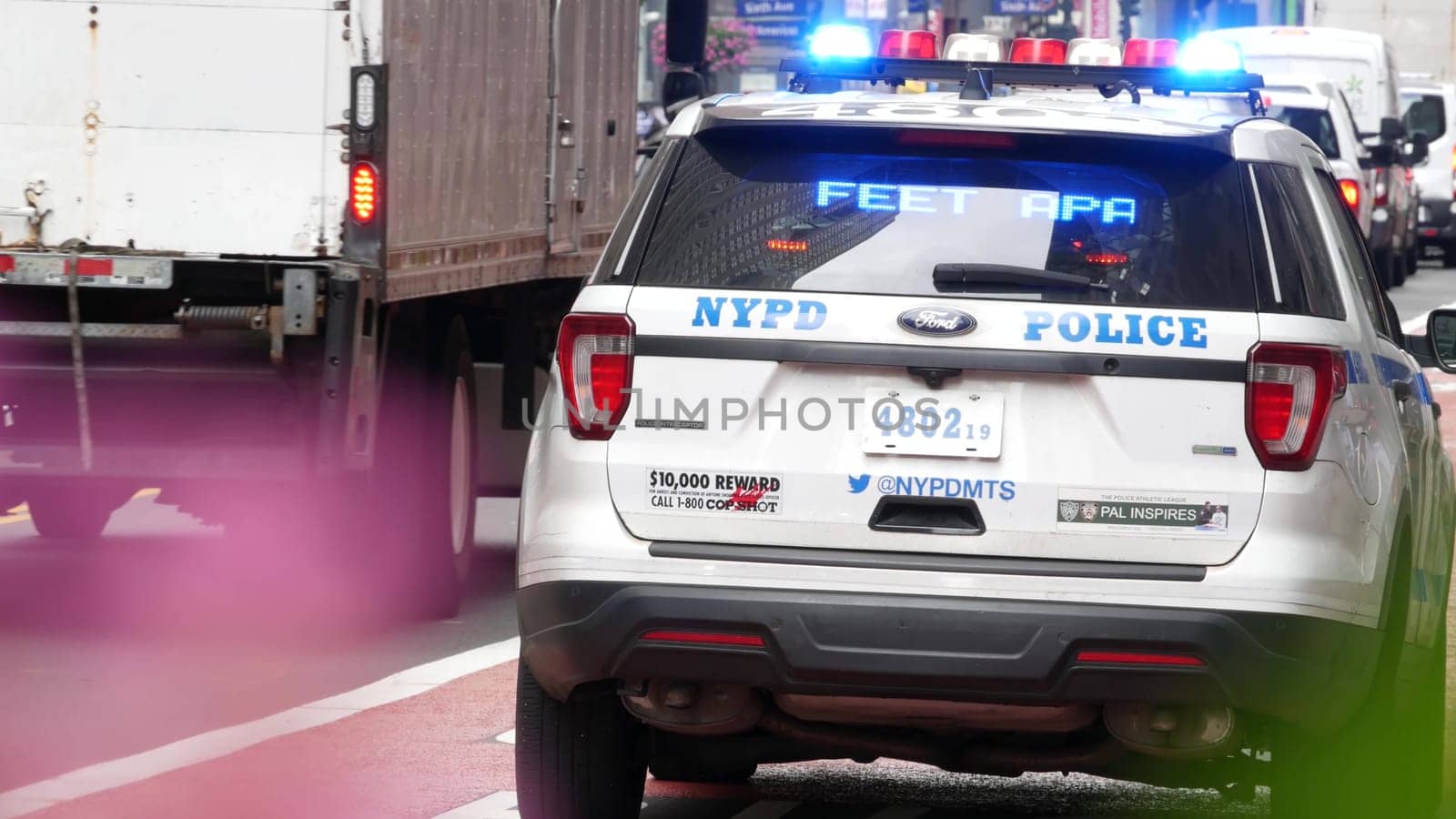 New York City, United States - 29 Aug 2023: Police patrol car, USA NYPD, 911 vehicle on Manhattan Midtown 34th street. American cop auto siren light on avenue. Urban traffic, road transport scene.