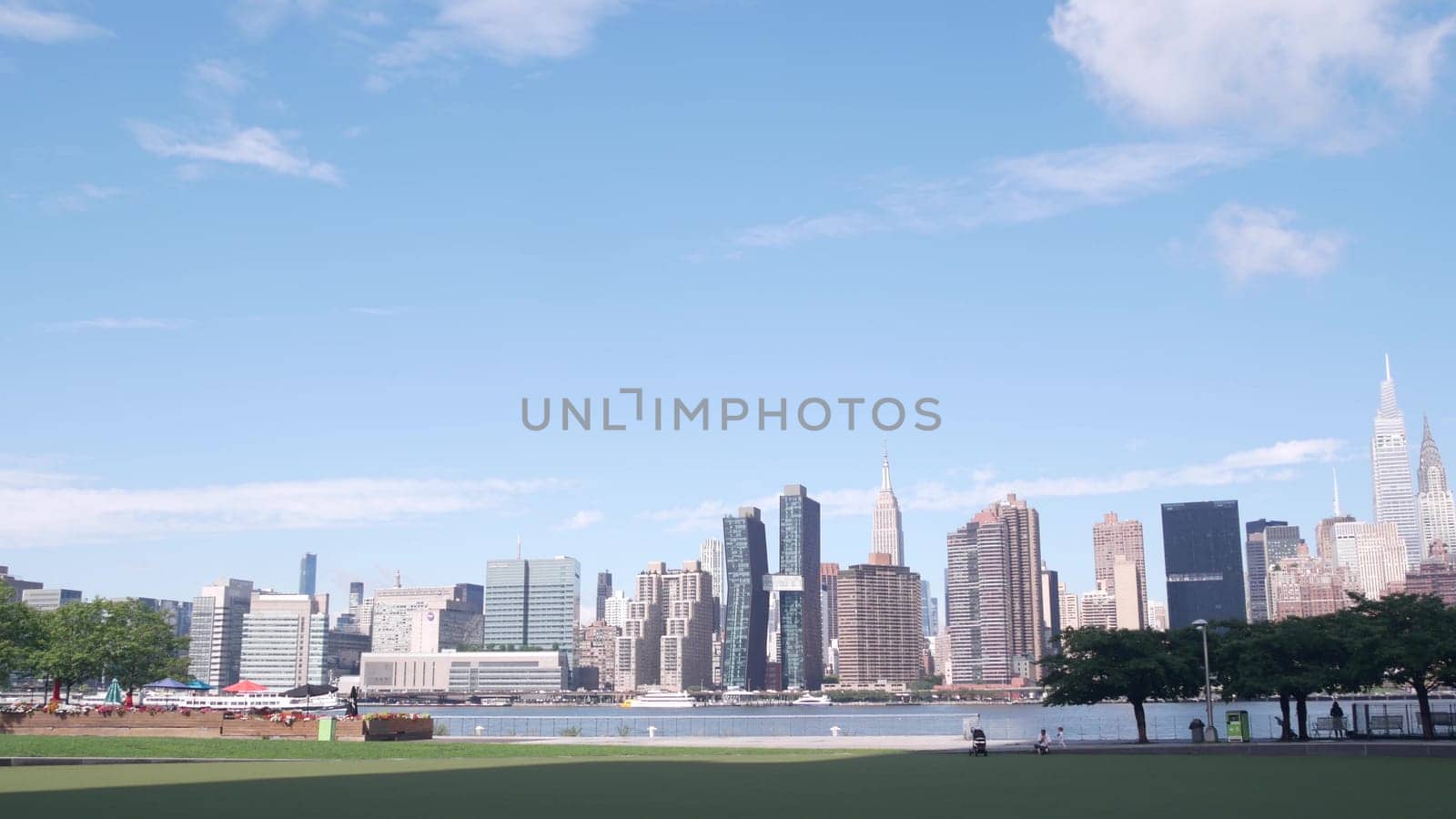 New York City, United States - 30 Aug 2023: Waterfront skyline, Manhattan Midtown buildings, riverfront skyscrapers, East river water. Waterside cityscape view from Hunters Point, Long Island, Queens.