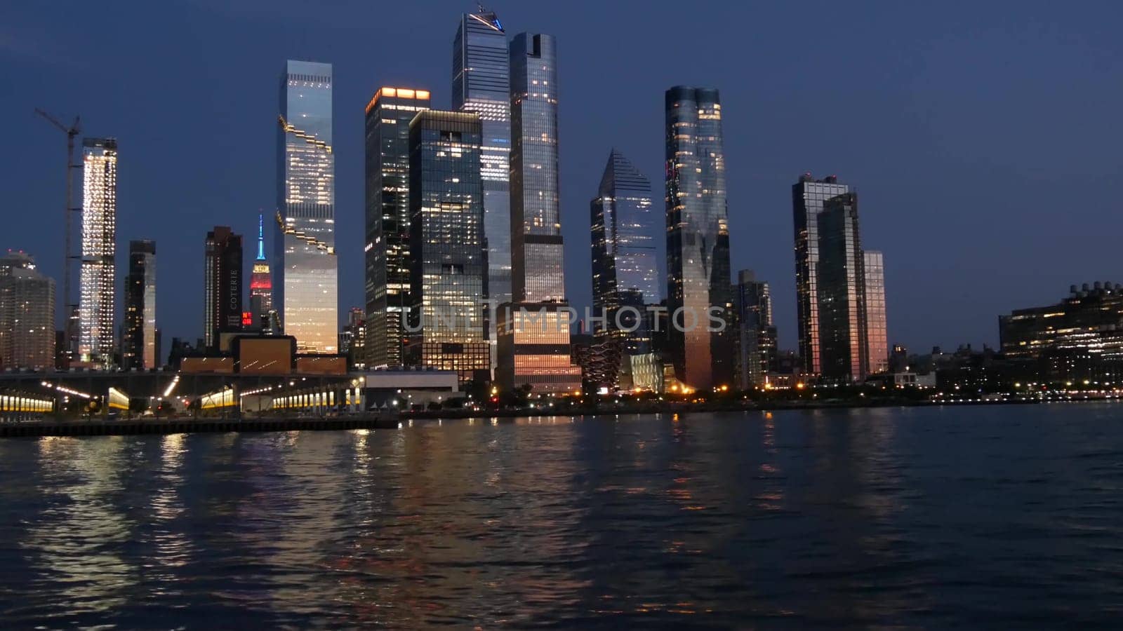 New York City, United States - 4 Sept 2023: Manhattan Midtown skyline from river ferry boat. Hudson Yards skyscrapers from ferryboat. Waterfront panorama riverfront architecture. Empire State Building