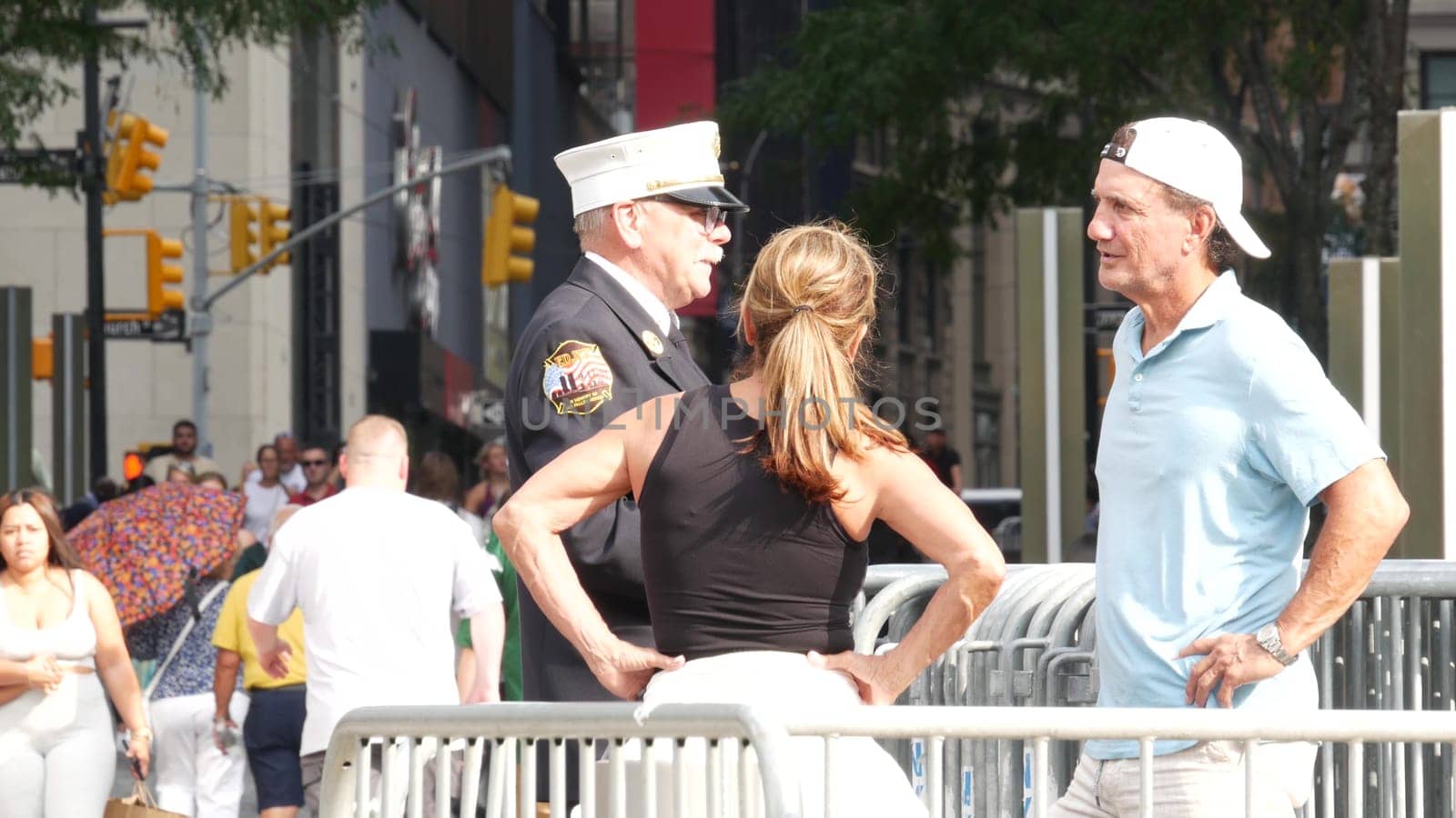 New York City, United States - 11 September 2023: Firefighters celebrate Patriot Day. FDNY officer near 911 Memorial Pools. Fire department old fireman talking to people on Manhattan Downtown, USA.