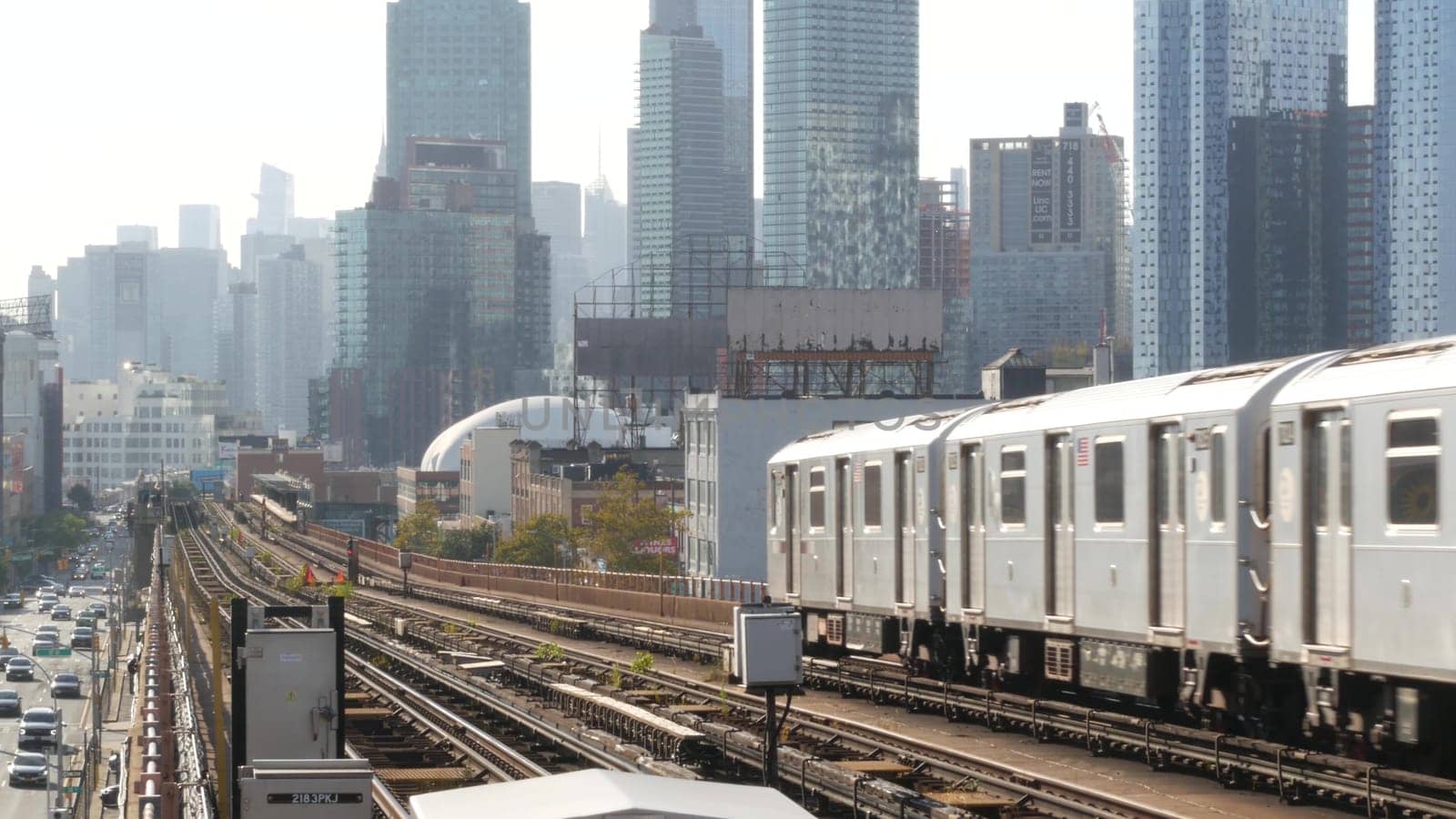 New York City, United States - 2 Sept 2023: Subway station. Metro train public transportation platform. Elevated outdoor railway, 7 line, Queens passenger railroad traffic. Manhattan cityscape skyline
