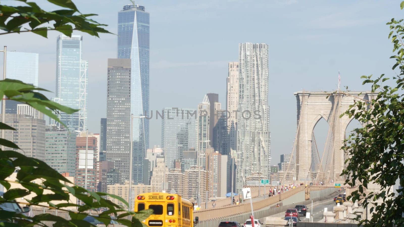 New York City, United States - 3 Sept 2023: Cars on Brooklyn Bridge from Manhattan downtown. Financial district skyline cityscape. Road traffic, people, architecture. World Trade Center skyscraper.