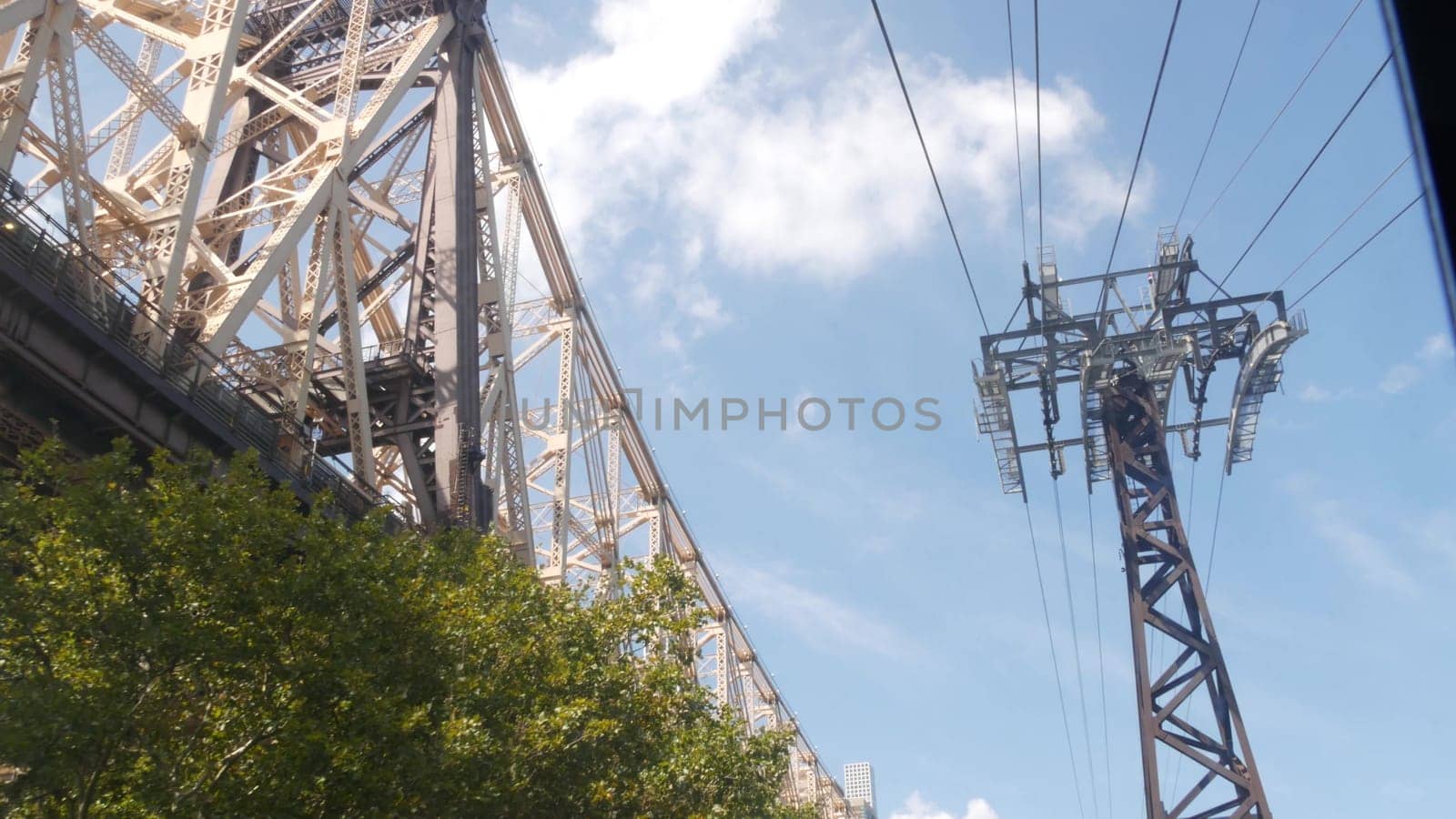 New York City, United States - 12 Sept 2023: Roosevelt Island tramway to Manhattan Midtown. American aerial cable tram near Queensboro Bridge. Urban public transportation, passenger transport in USA.
