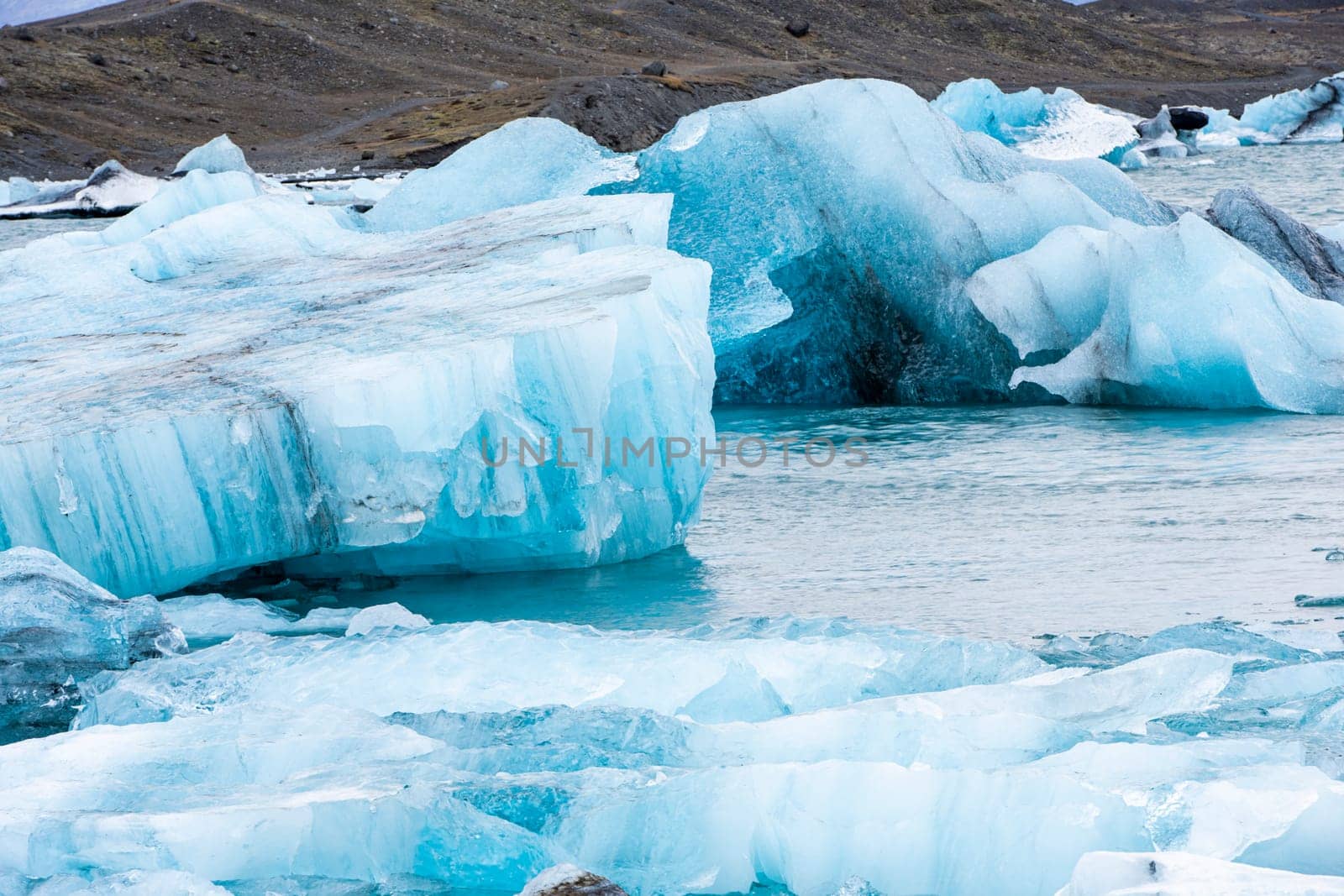 View of the melting glacier on Jokulsarlon or Jökulsárlón Glacier Lagoon, Iceland. Nature, travel, climate change, global warming, winter background, or wallpaper
