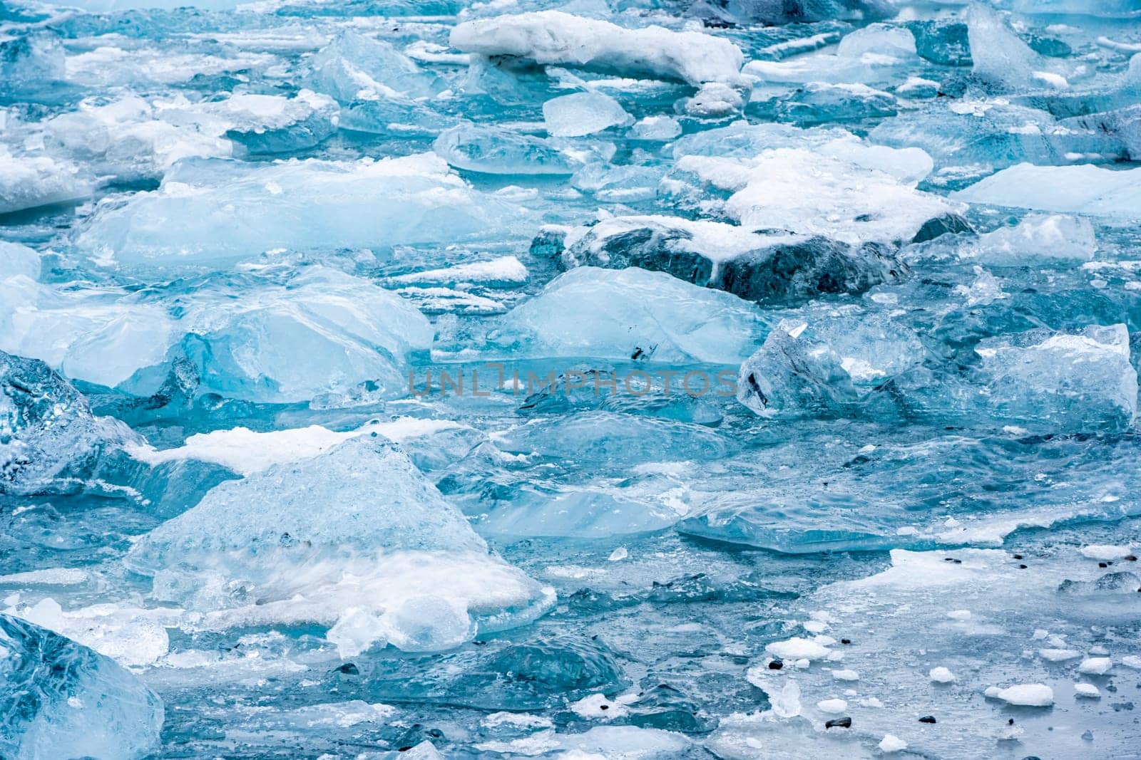 View of the melting glacier on Jokulsarlon or Jökulsárlón Glacier Lagoon, Iceland. Nature, travel, climate change, global warming, winter background, or wallpaper