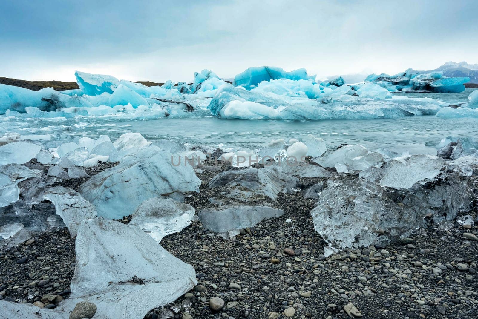 View of the melting glacier on Jokulsarlon or Jökulsárlón Glacier Lagoon, Iceland. Nature, travel, climate change, global warming, winter background, or wallpaper
