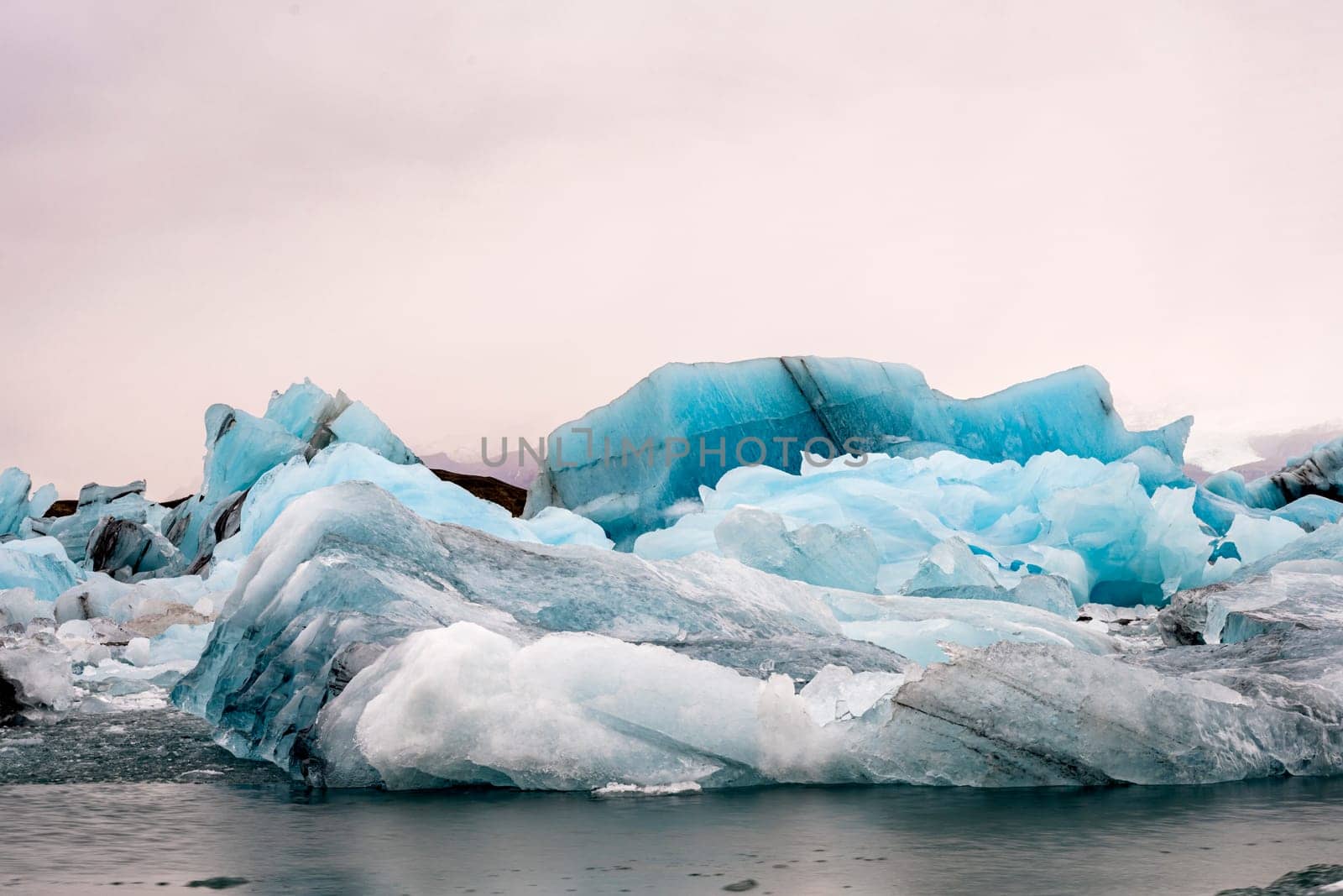 View of the melting glacier on Jokulsarlon or Jökulsárlón Glacier Lagoon, Iceland. Nature, travel, climate change, global warming, winter background, or wallpaper