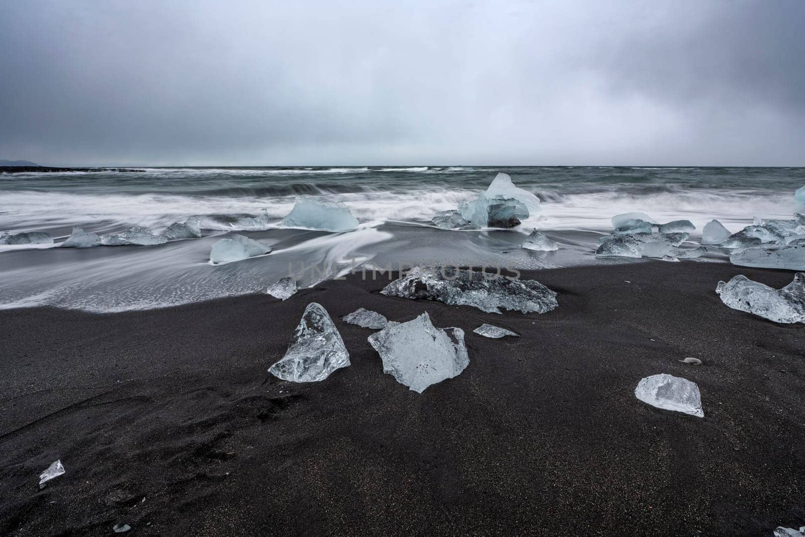 View of the melting glacier on the diamond beach on Jokulsarlon or Jökulsárlón, Iceland. Nature, travel, climate change, global warming, winter background, or wallpaper