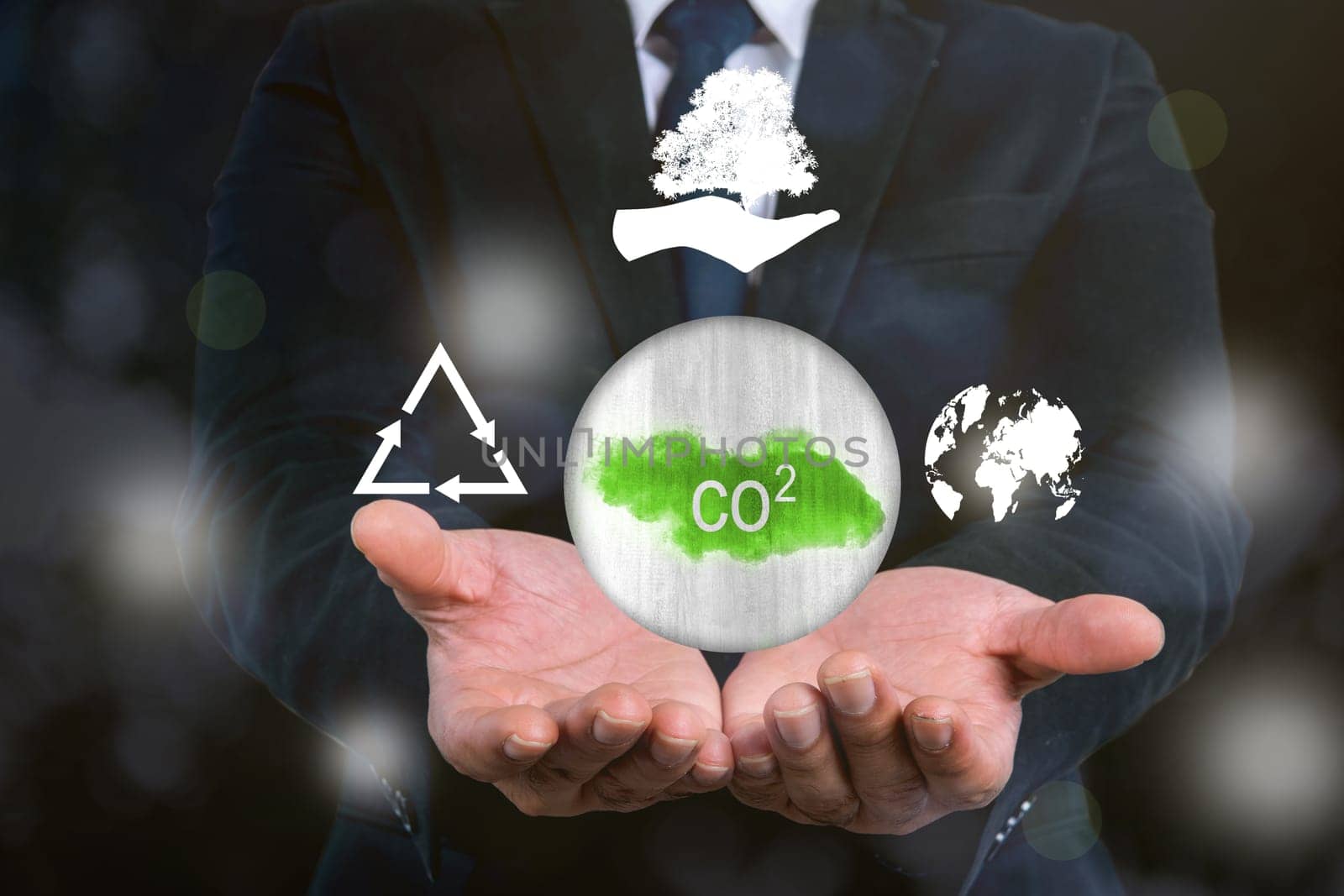 Business hand shows a sign of carbon reduction for decreased CO2. Concepts of environmental protection, climate change, global warming, recycling, or net zero carbon neutral