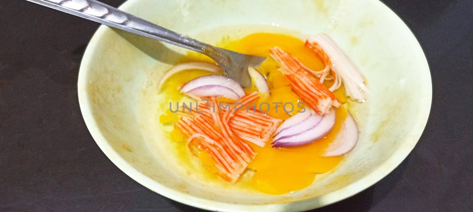 Preparing eggs to make omelette menu, crab stick omelet with onion, Thai food