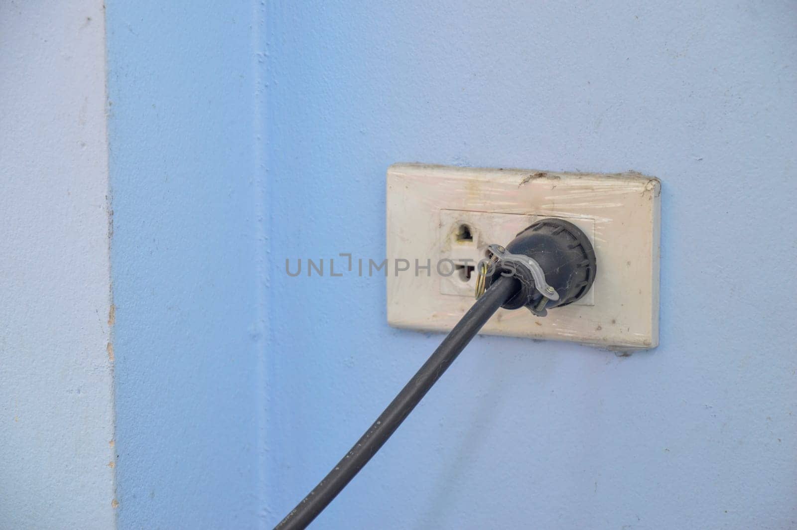 The power plug is plugged into the wall outlet.